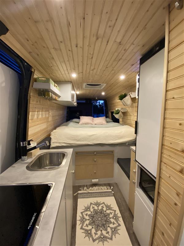 Step into this bright RV rental with wood paneling, a full kitchenette, cozy bed, and modern amenities.. Field Van Sprinter Mercedes 2014