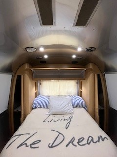Airstream RV rental: Polished bedroom with "Living The Dream" blanket. Your next travel adventure awaits!. Airstream Flying Cloud 2016