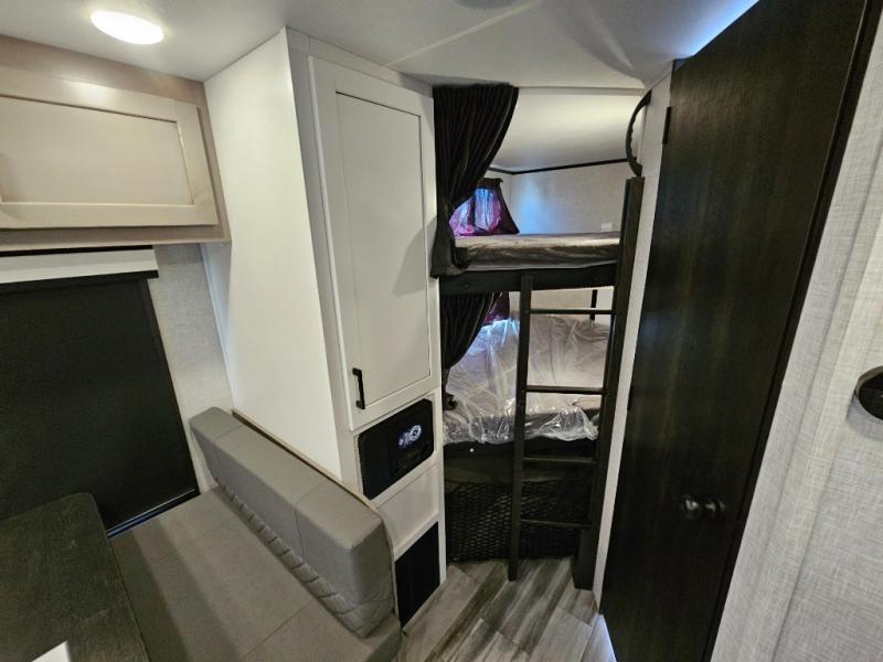 RV rental interior: bunk beds, a dinette, and built-in storage optimize this compact living space for travel.. Jayco Jay Feather 2024