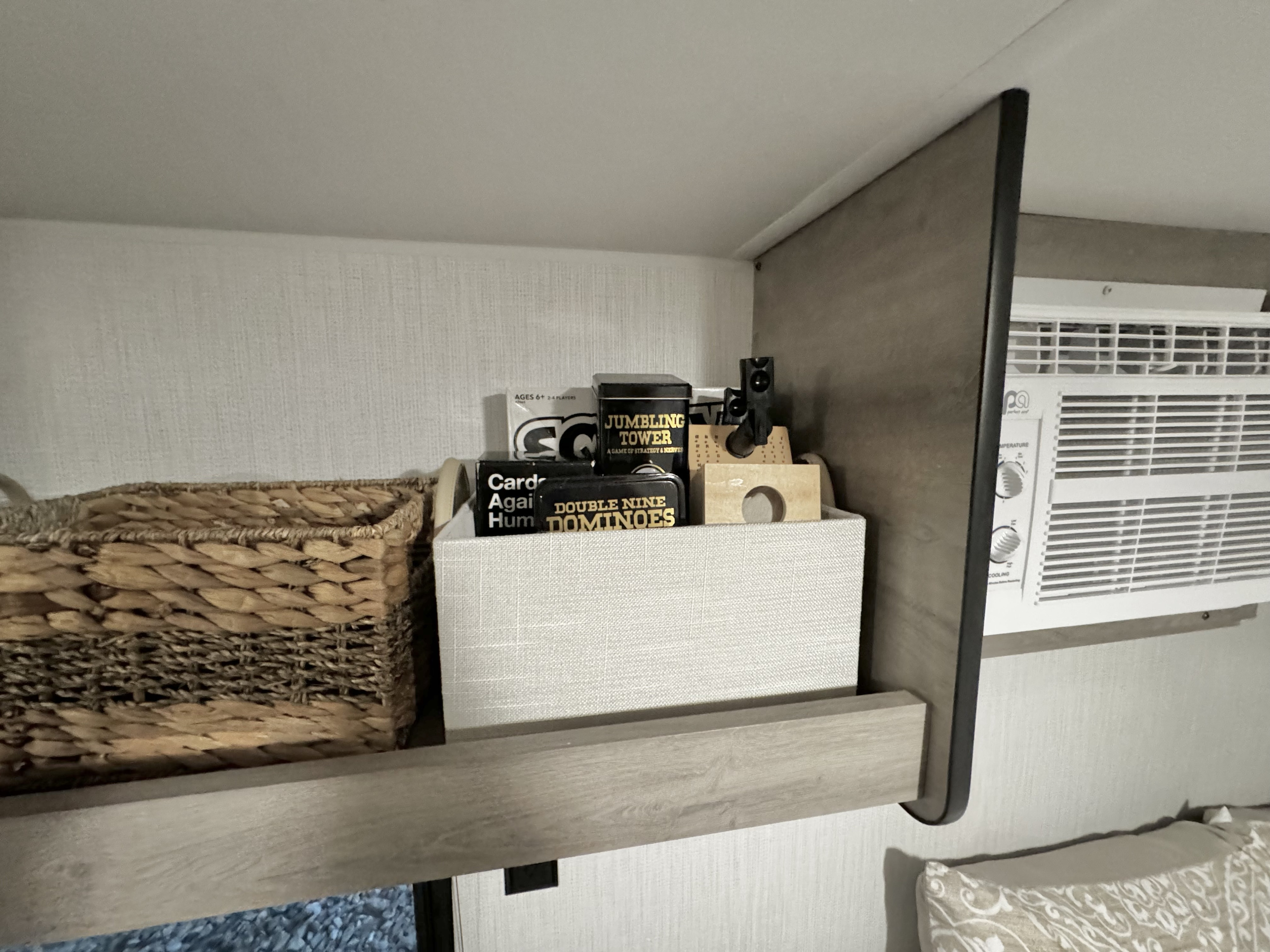 Your rv rental offers comfort & entertainment! Shelf with games (Jumbling Tower, Dominoes), basket storage, and an AC unit.. Cruiser RV Avenir 2024