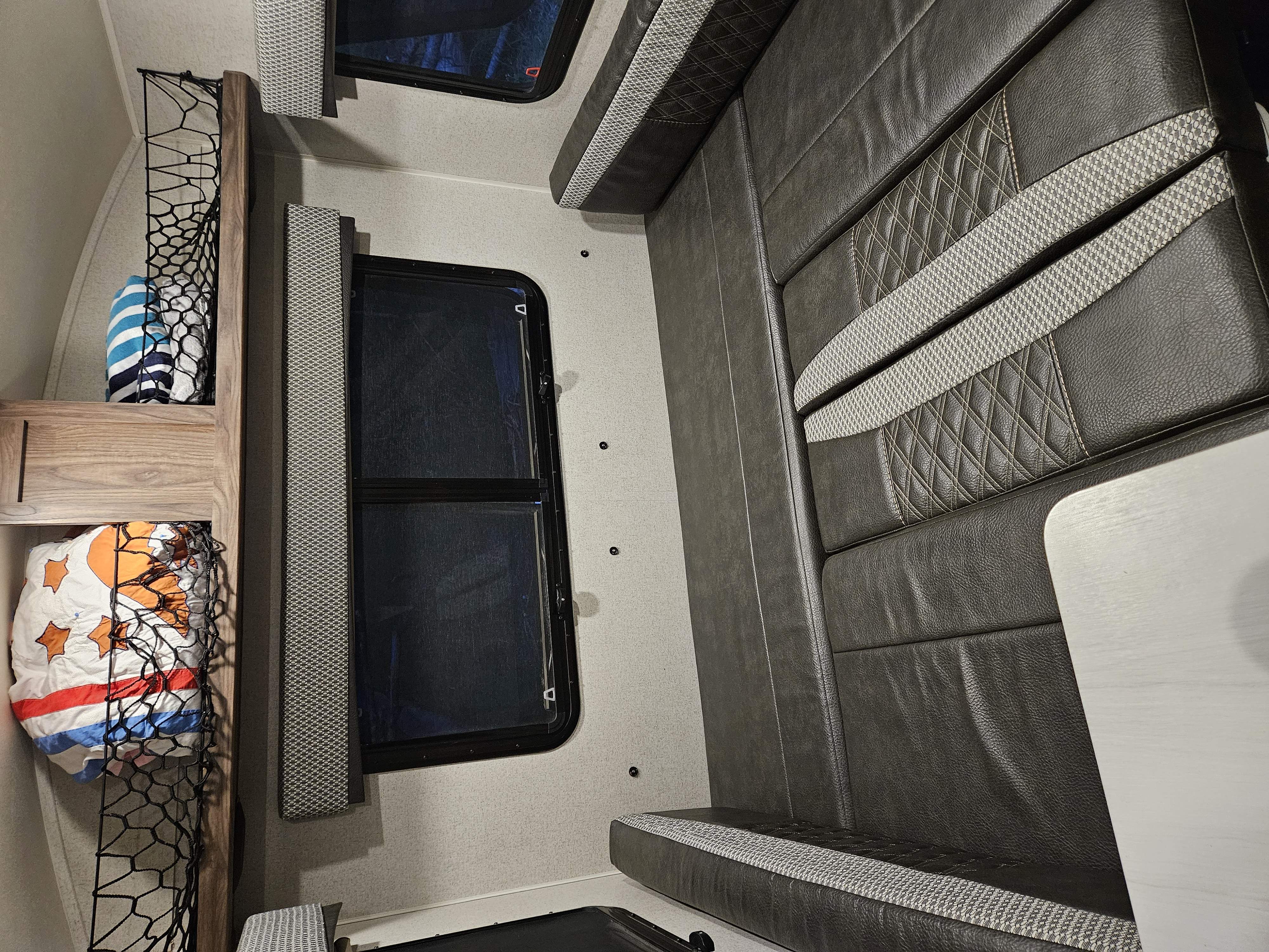 Step inside this rv rental: featuring bunk beds with convenient storage nets and a comfortable dinette with patterned upholstery.. Forest River Rockwood Geo Pro 2018