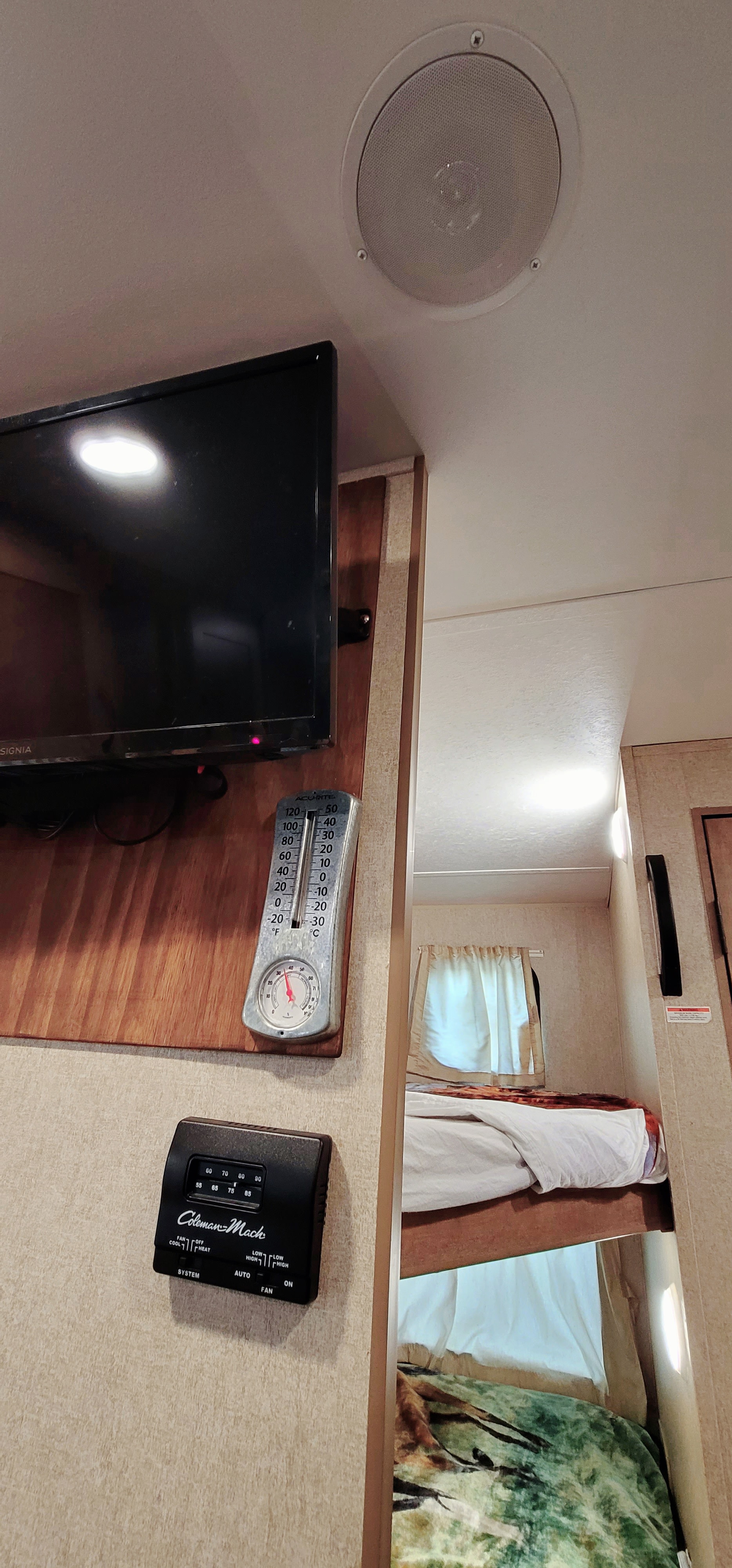 RV rental interior: TV, ceiling speaker, thermometer, Coleman-Mach thermostat, and bunk beds for comfort.. Starcraft AR-One Maxx 2017
