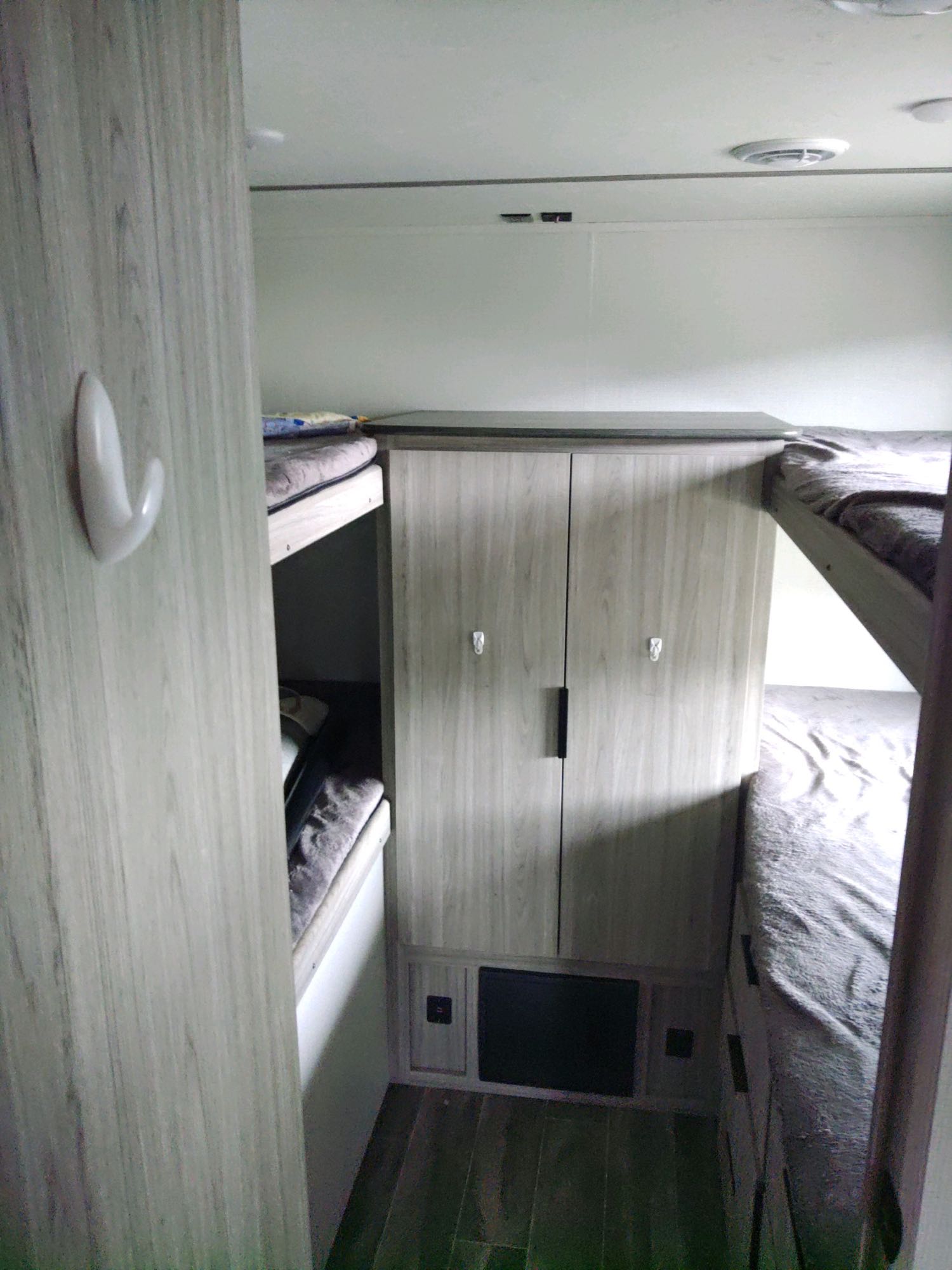 This RV rental features a bunkhouse design with multiple beds and central storage, ideal for families.. Keystone RV Passport SL 2021