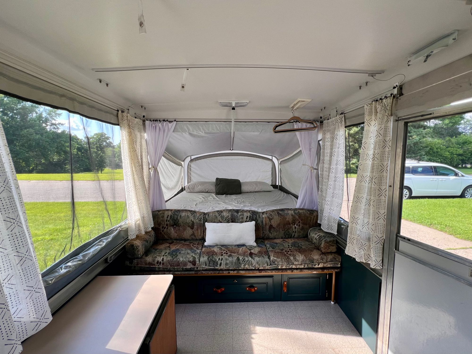Step inside this inviting pop-up RV rental! Comfortable sofa, bed, and scenic window views for your adventure.. Coleman Sun Valley 2002