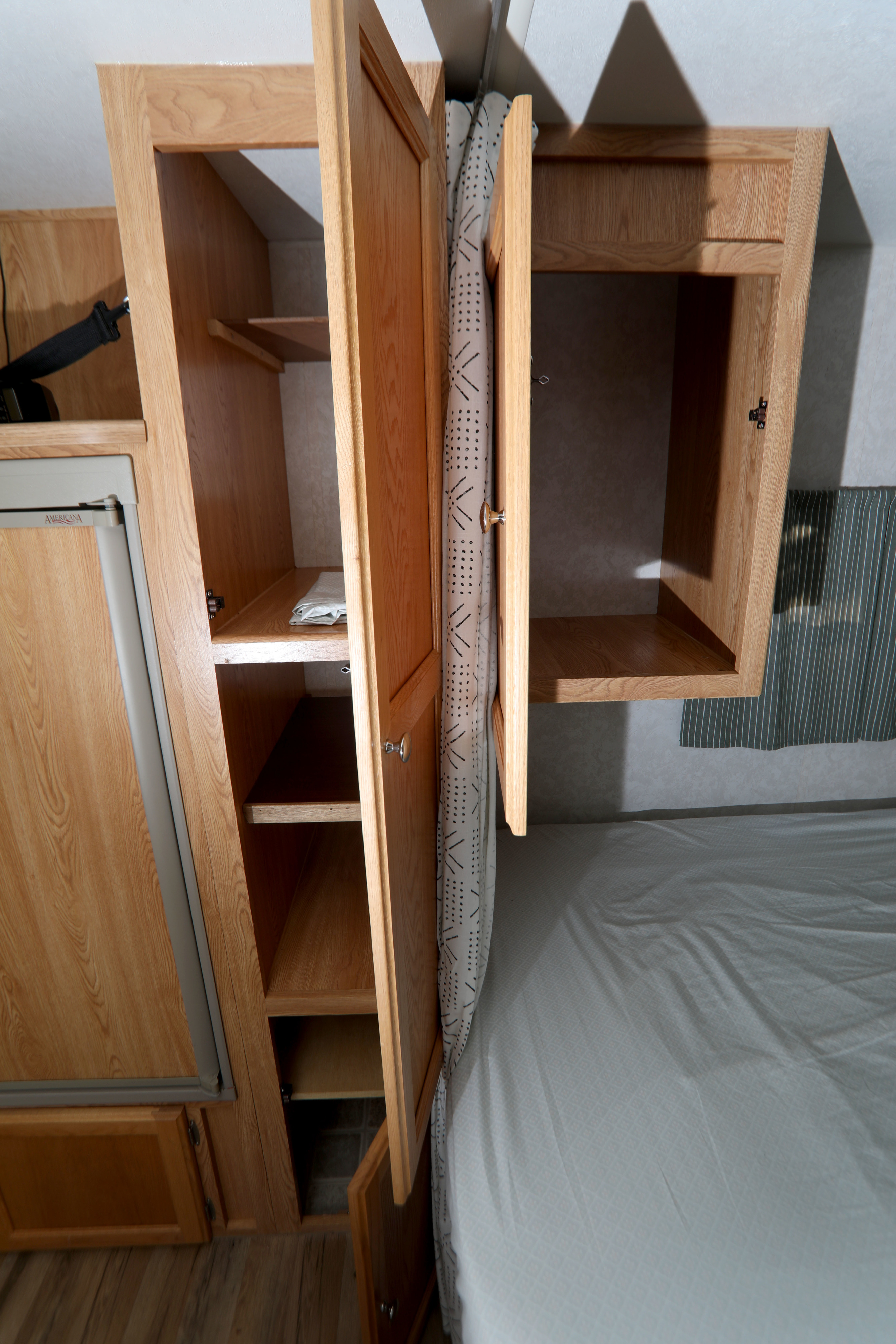 RV rental interior: open wooden cabinets, fridge, and bed for organized travel. Ample storage visible.. R-Vision Trail-Lite Trail-Cruiser 2003