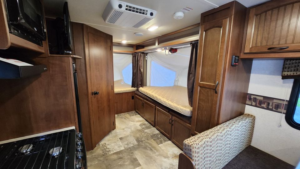 Clean RV rental interior featuring a kitchen, two pop-out sleeping berths, and a cozy dinette. Ideal camper.. Jayco Jay Feather Ultra Lite 2015