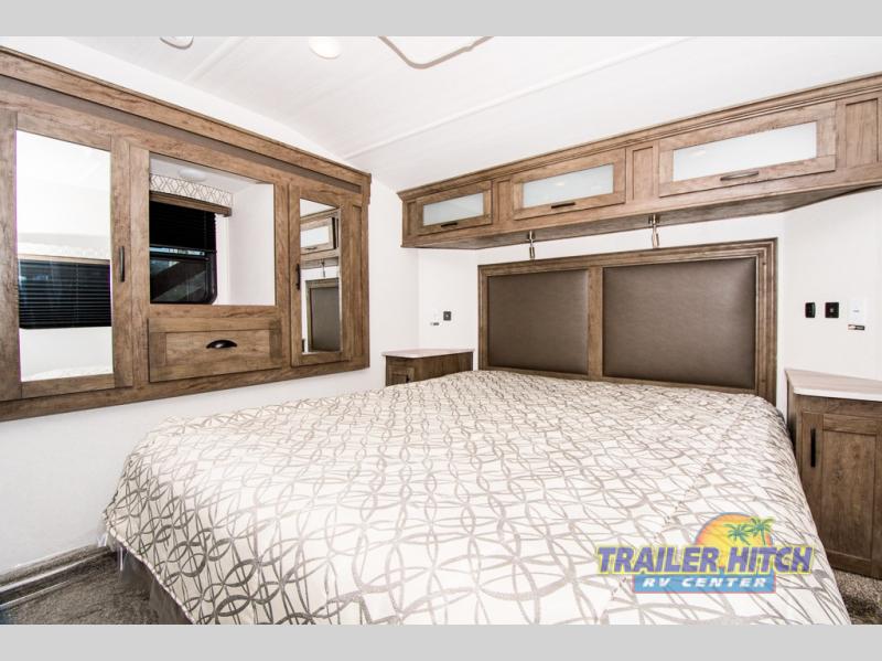Spacious RV bedroom perfect for your rv rental, with a comfy bed, overhead storage & built-in mirrored wardrobes.. Forest River Stealth 2020