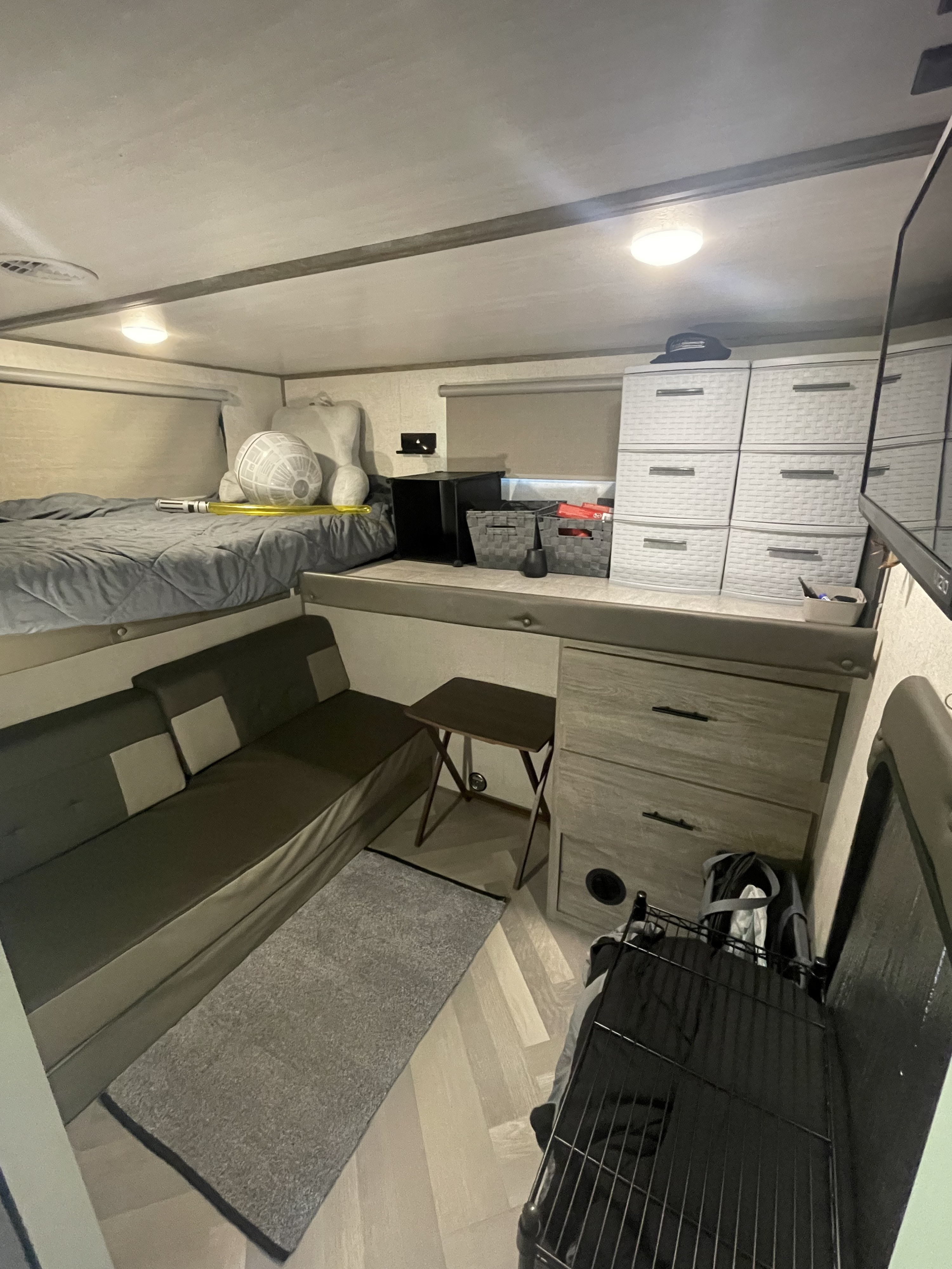 RV rental interior: cozy bunk bed, sofa, and storage solutions for a comfortable travel experience.. Forest River Wildwood Heritage Glen HL 2021
