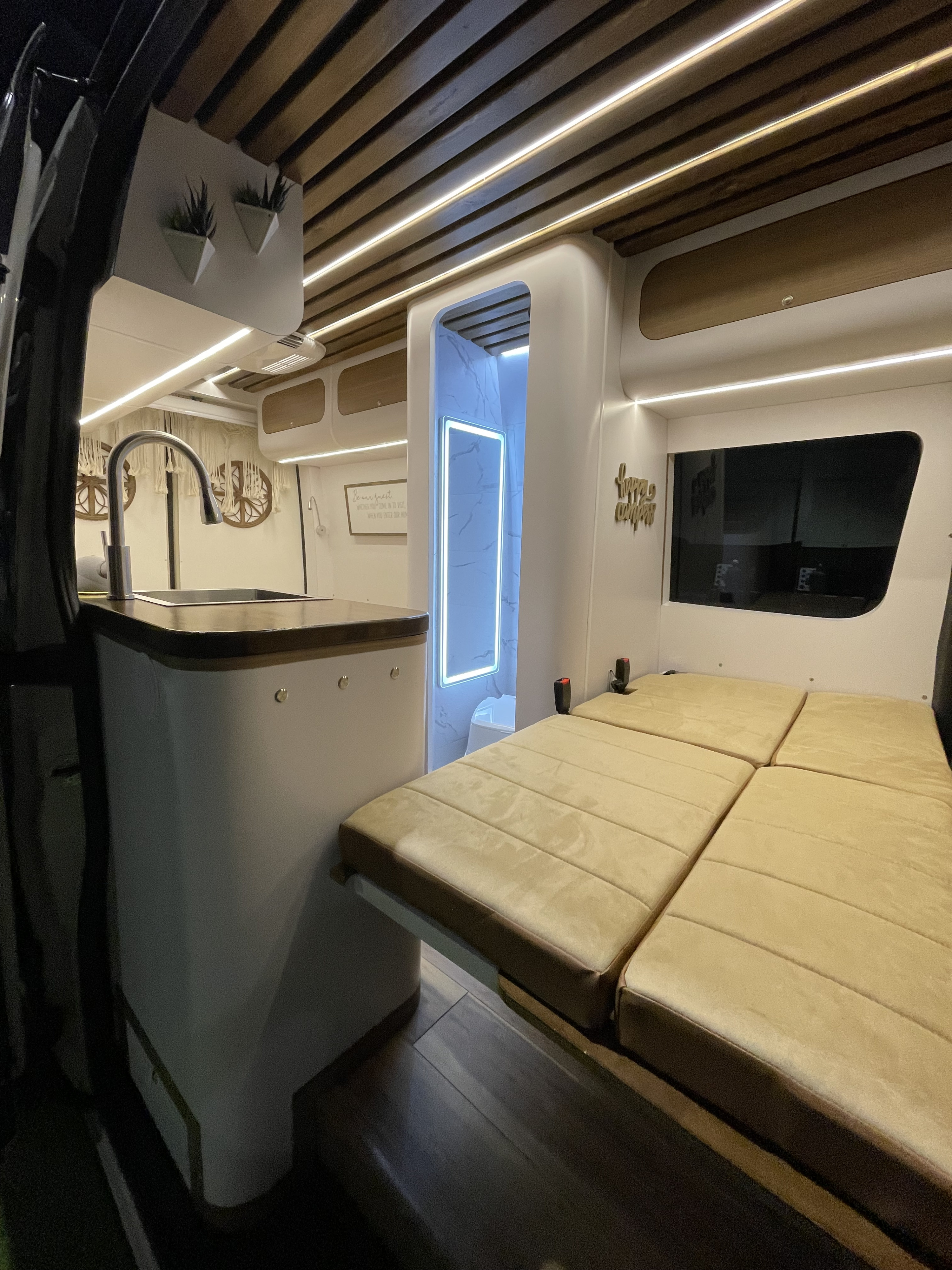 Modern RV rental interior with kitchen, illuminated shower, and convertible bed for a comfortable journey.. Mercedes-Benz sprinter 2022