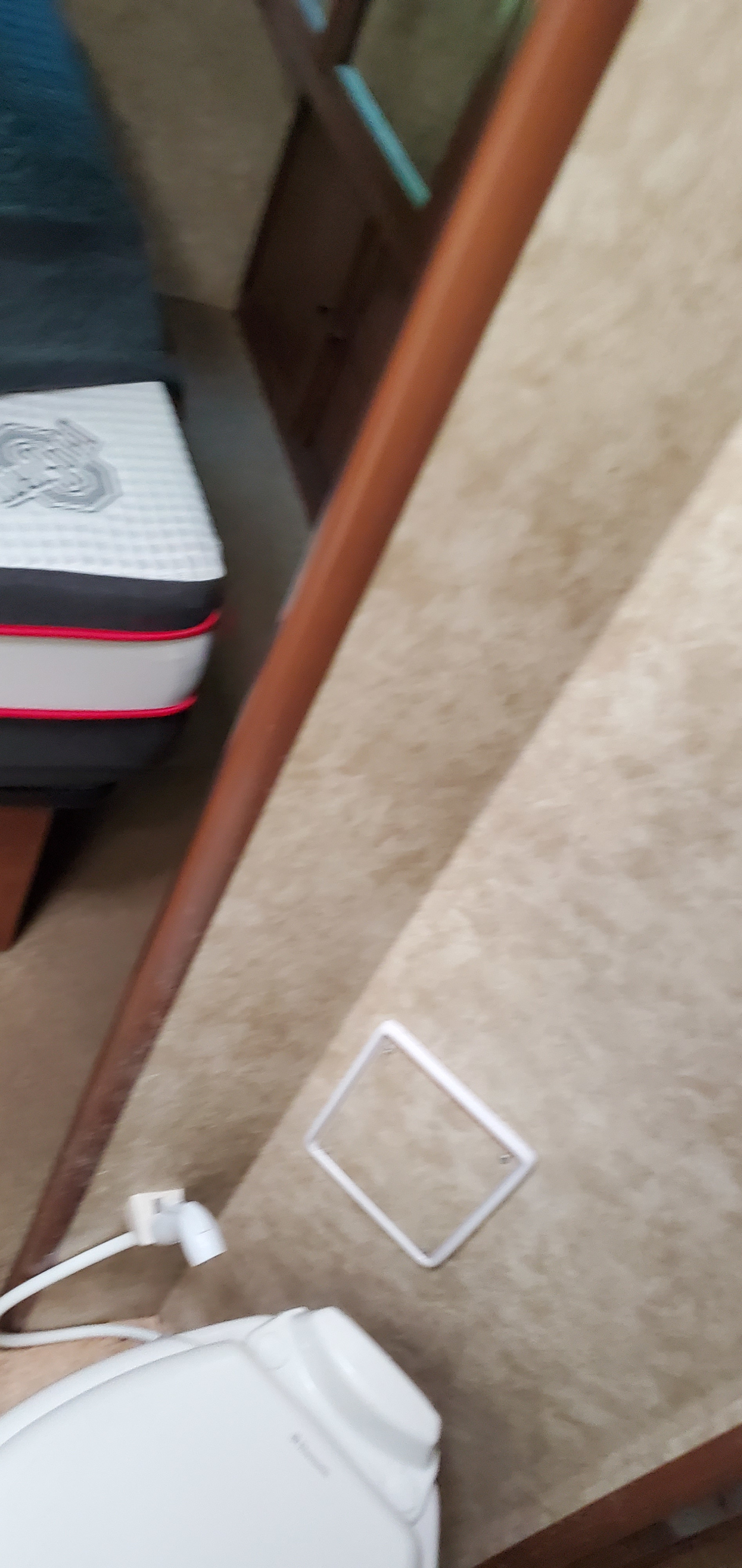 RV rental interior: A compact view showcasing a patterned mattress, white toilet, and wall-mounted connection point.. Jamboree Sport 2013