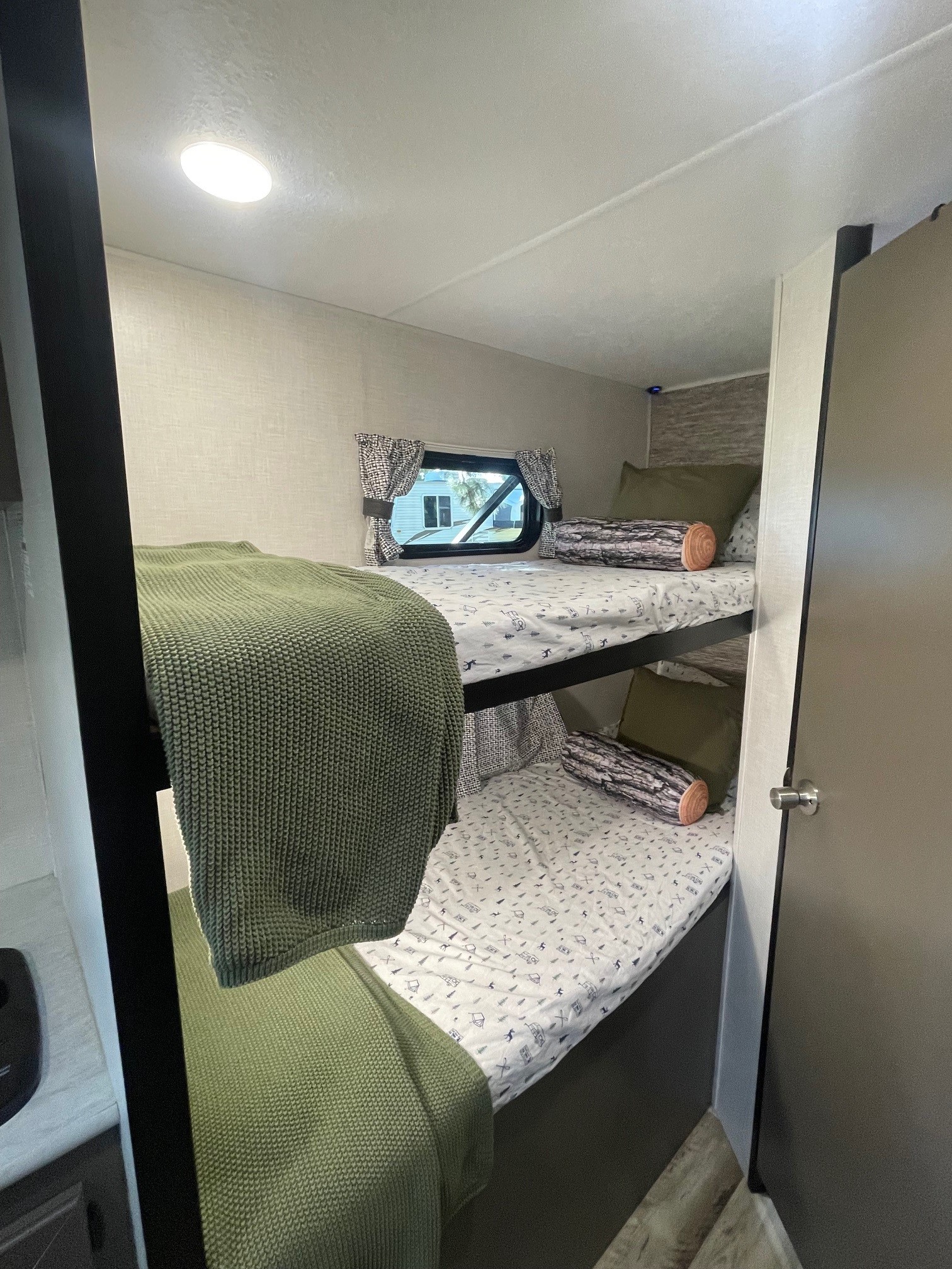 RV rental bunk beds: cozy sleeping area with themed linens and unique log pillows for campers.. KZ SPORTSMEN CLASSIC 191BHK 2024
