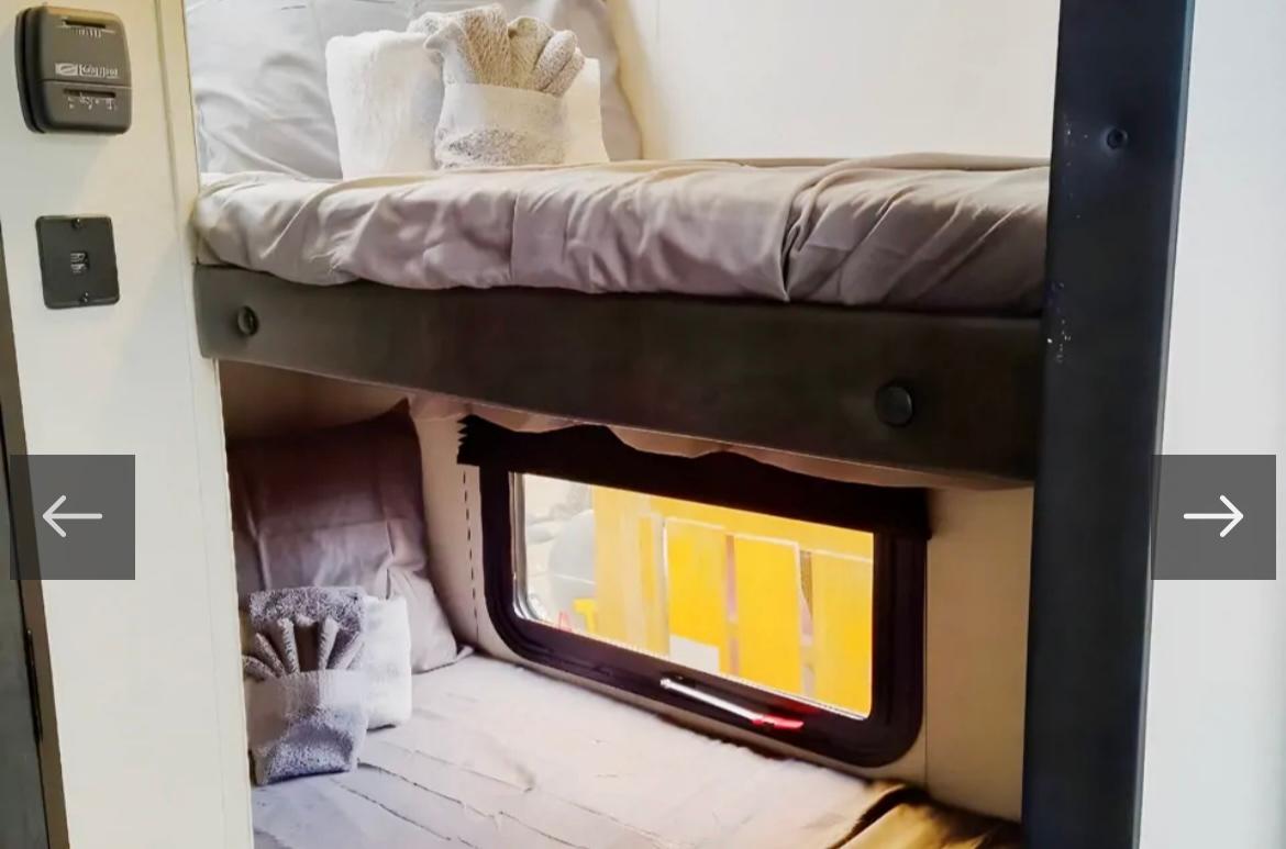 Cozy RV rental bunk beds with a window and thermostat. Perfect for family travel and camping adventures.. Avenger LT 2021