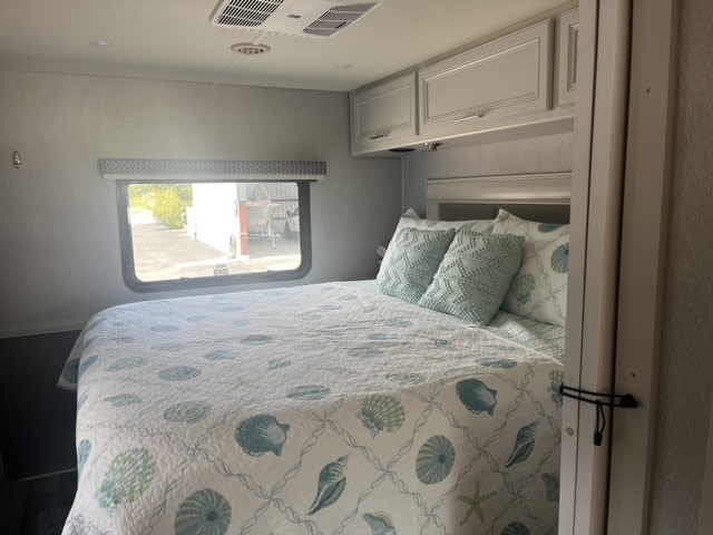 Comfortable RV rental bedroom with a marine-themed bed and window view. Ideal for your travel stay.. Holiday Rambler Admiral 2022