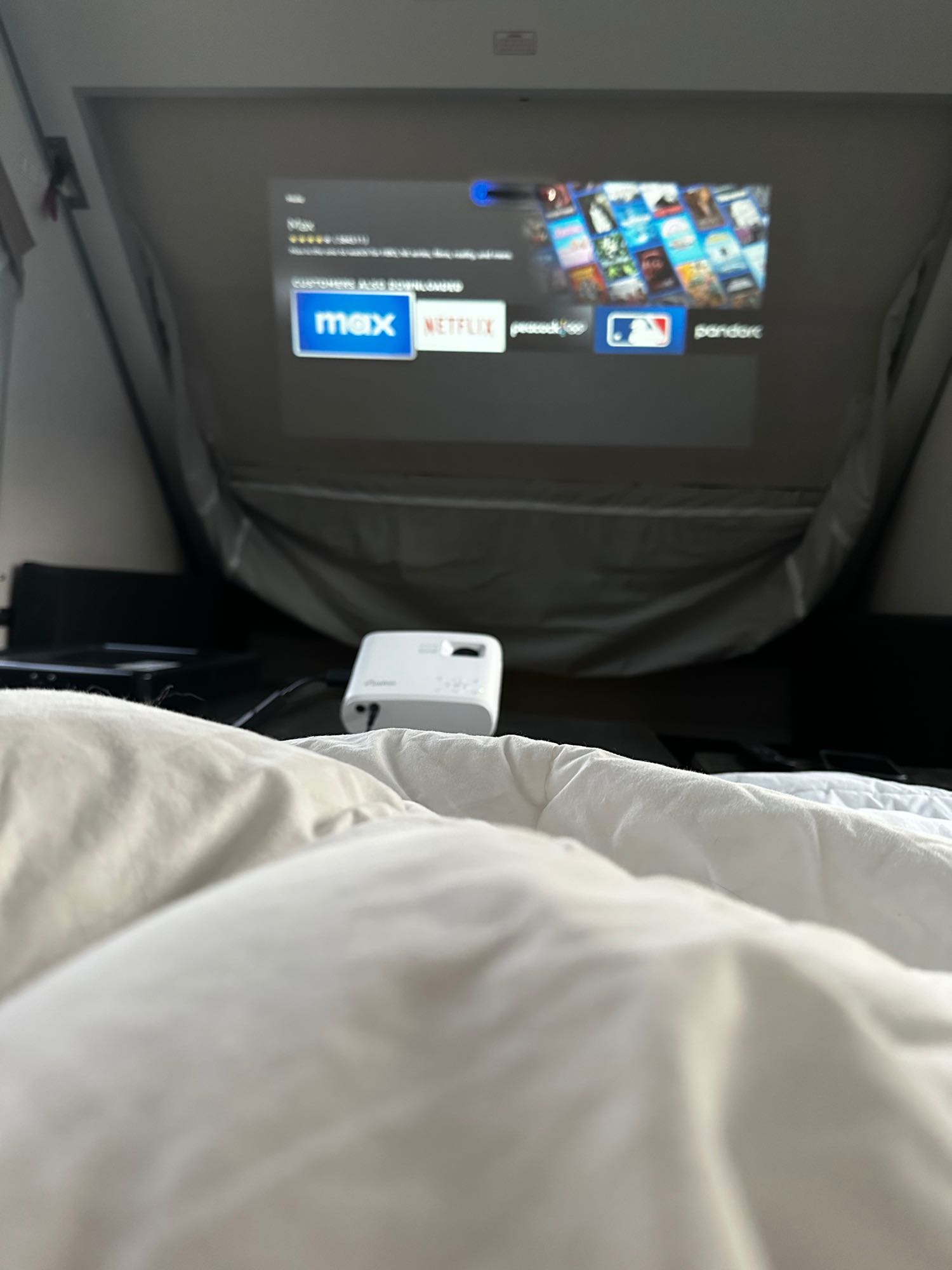 Enjoying a cozy RV rental movie night! A projector streams Netflix, Max, and MLB inside the camper.. A Liner Ranger 12 2023