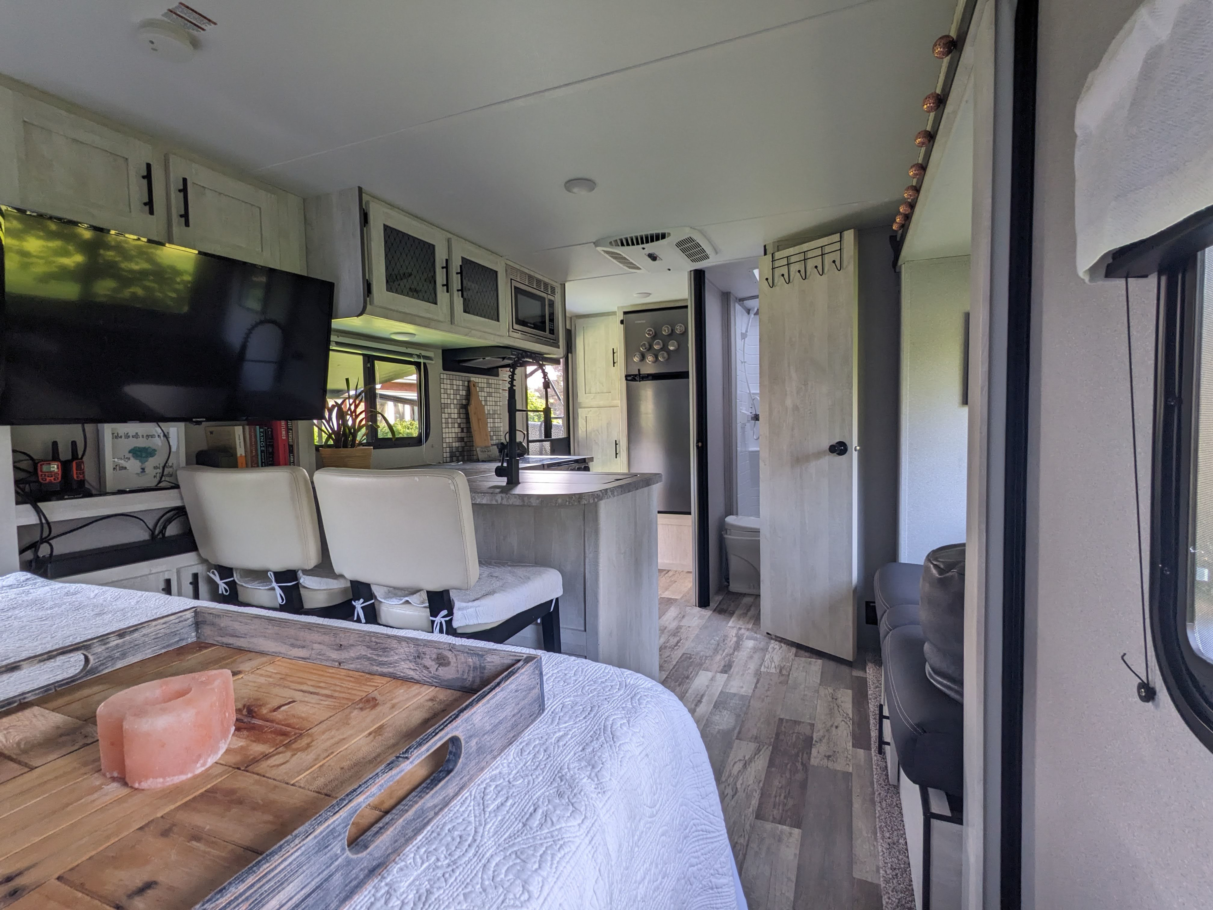 Modern RV rental interior: well-appointed kitchen, comfortable bedroom, and accessible bathroom create a home-like living space.. Forest River Shasta 2020
