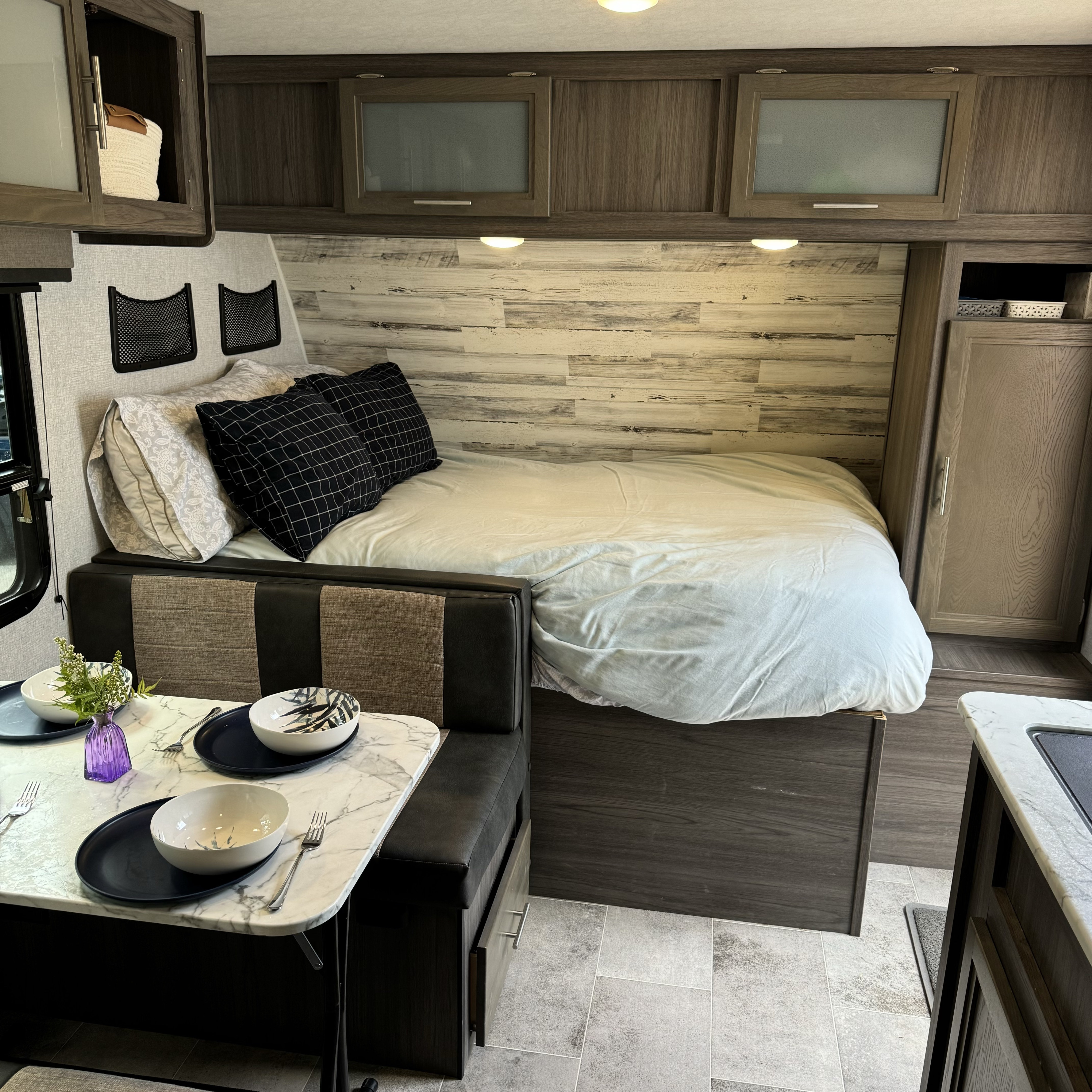 Inside this RV rental: a comfortable bed, dinette, and practical storage solutions. Perfect for your next adventure on the road.. Dutchmen Kodiak Cub 2020