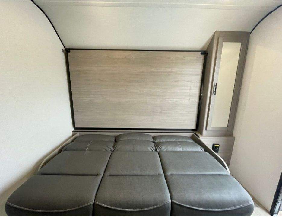 This RV rental features a clever interior with a versatile sofa bed and a mirrored cabinet for compact comfort.. Dutchmen Coleman 1905BH 2024