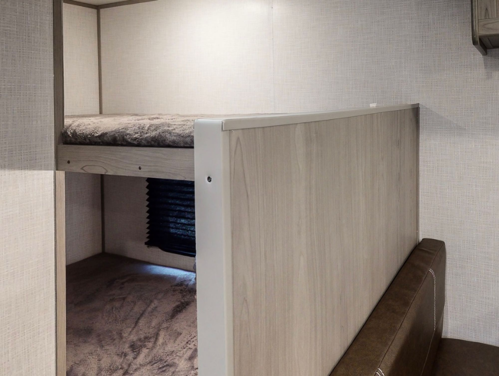 Compact RV rental interior featuring cozy bunk beds for comfortable travel and sleeping arrangements.. Dutchmen Coleman Lantern LT 17B 2024
