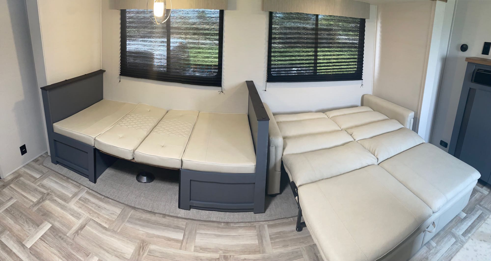 RV rental showcasing a versatile interior with cream convertible sofa and dinette beds, light wood-look flooring, and windows.. Prime Time 270BHSLE 2024