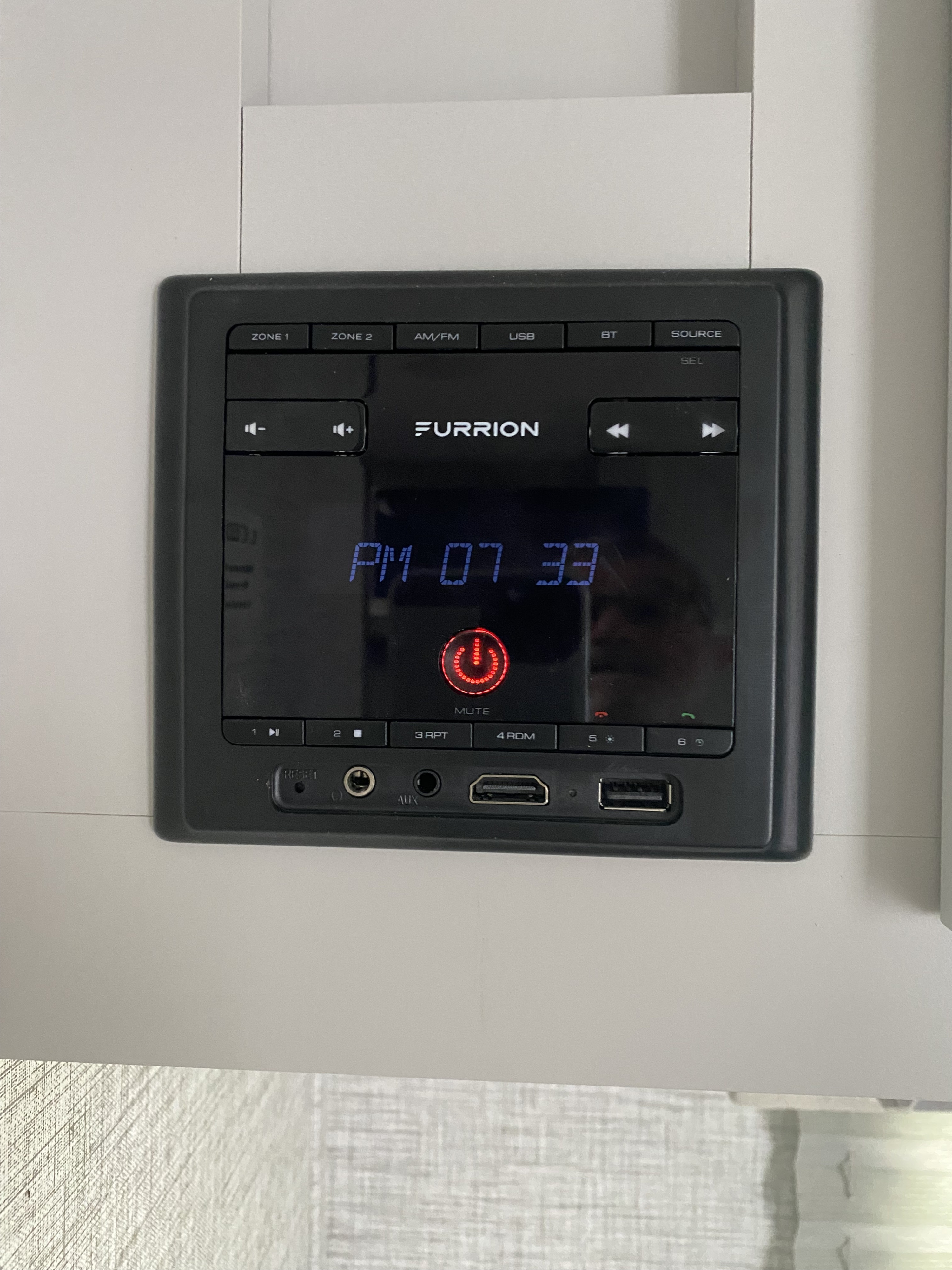 Furrion entertainment control panel in an RV rental, displaying PM 07 33. Features USB, AUX, HDMI, Bluetooth, and audio zones.. Keystone RV Bullet Crossfire 2021