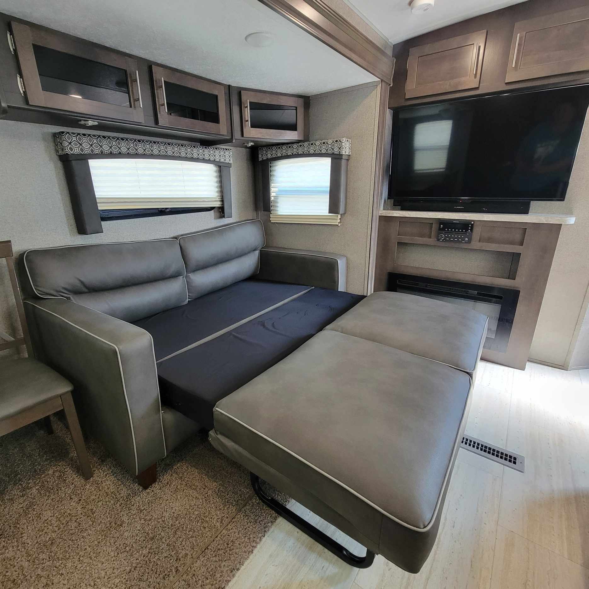 RV rental: Spacious interior with pull-out sofa bed, TV, fireplace, and ample cabinet storage.. Forest River Flagstaff Super Lite 2019