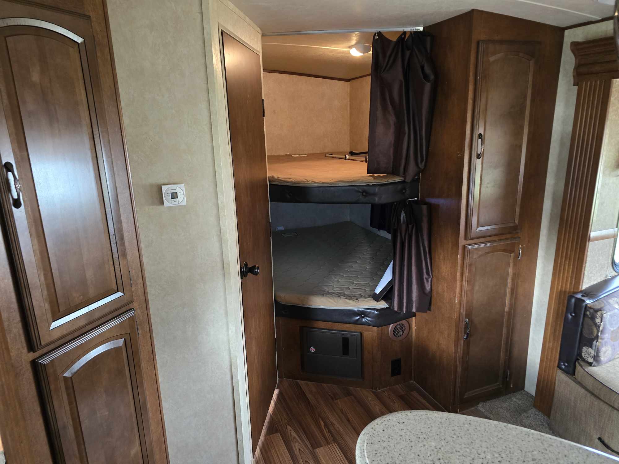 RV rental interior with cozy bunk beds, ample storage, and warm wood finishes. Perfect for family adventures.. Forest River Wildwood Heritage Glen Lite 2014