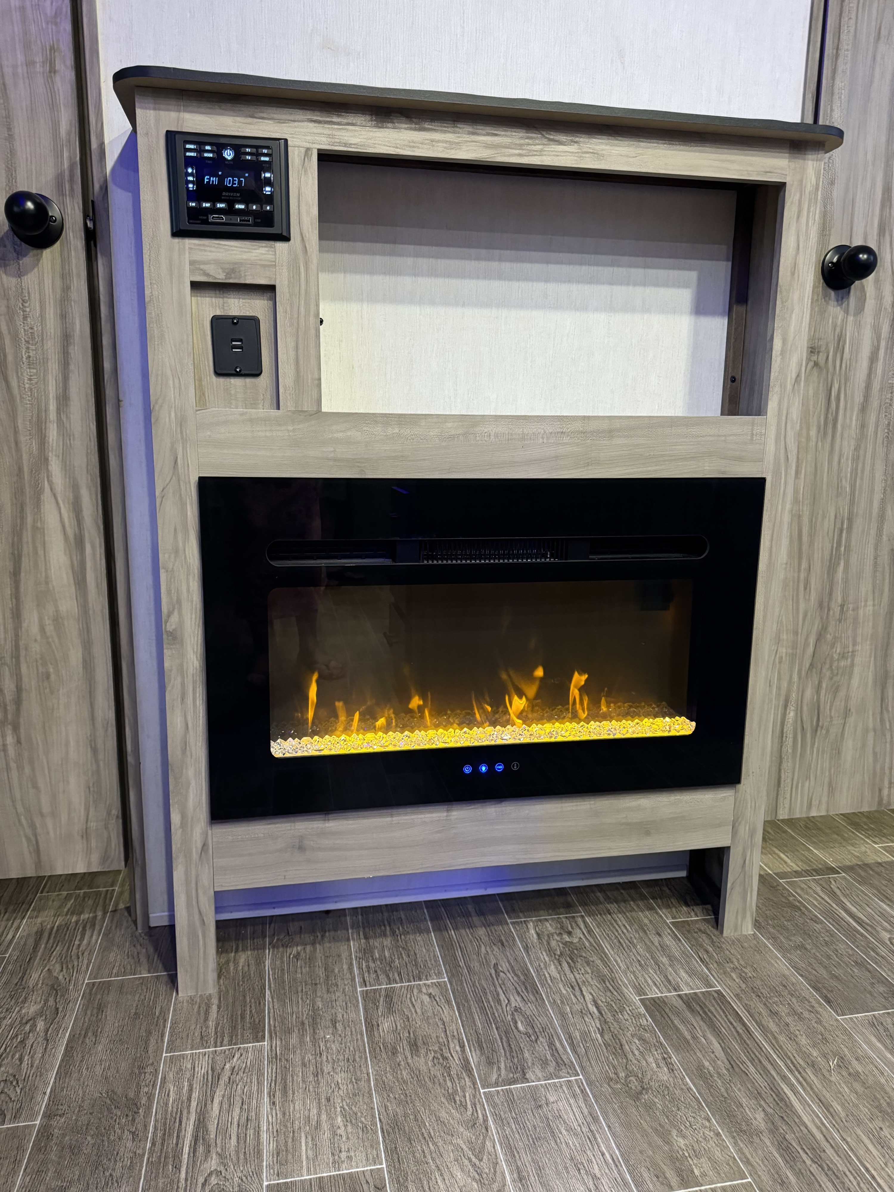 Cozy RV rental entertainment center with electric fireplace, multimedia controls & USB port.. Forest River Cherokee Alpha Wolf 2021