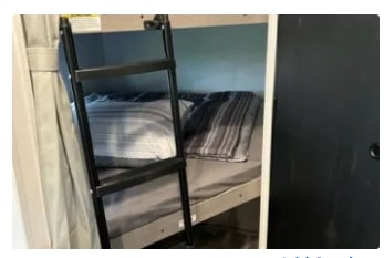 RV rental interior: bunk beds with ladder access. Compact, cozy sleeping for travel accommodation.. Dutchmen Kodiak SE 2024