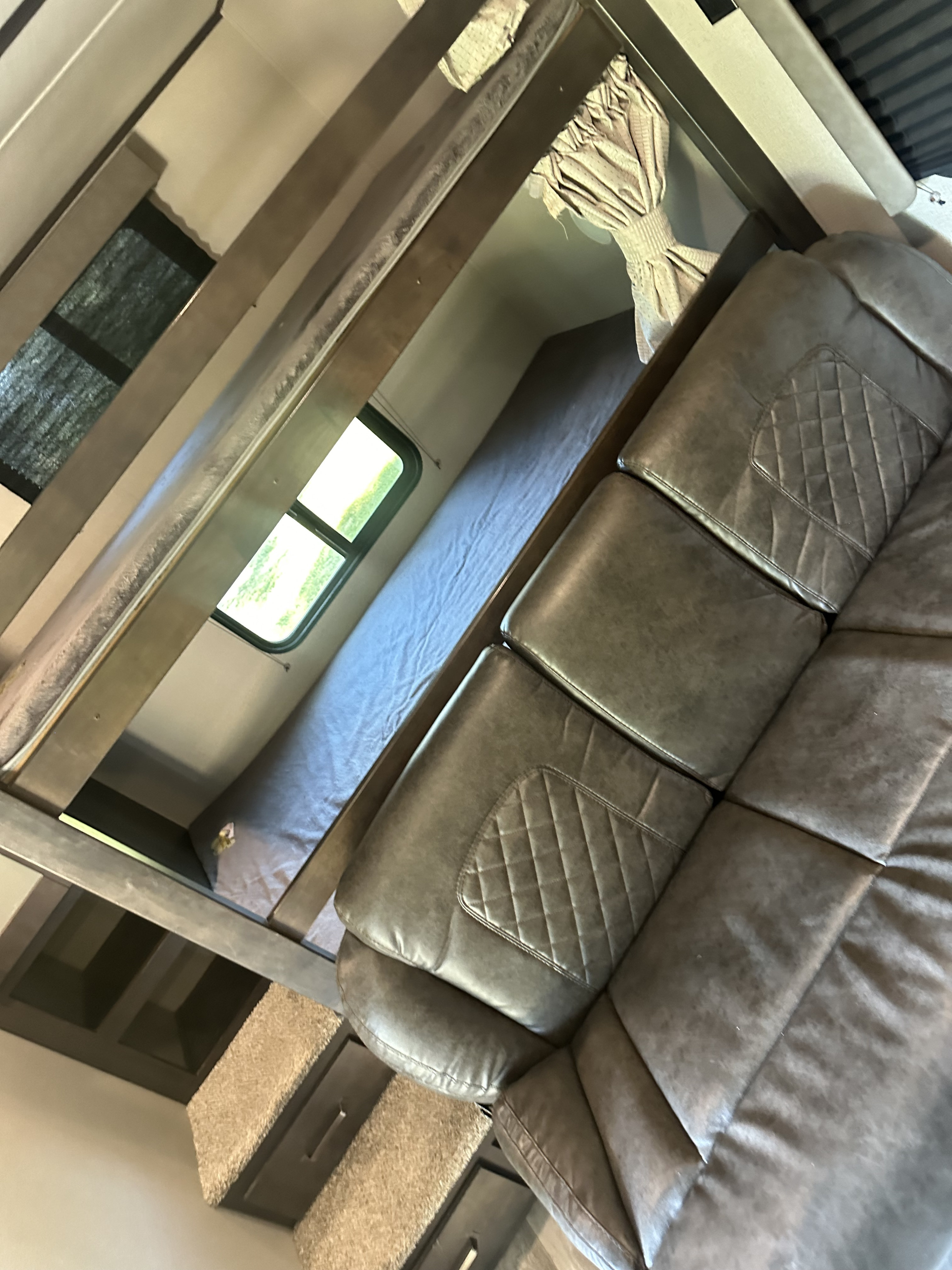 RV rental: Interior view showing a grey quilted sofa, bunk beds, and window. Perfect for a family trip.. Grand Design Transcend Xplor 2020