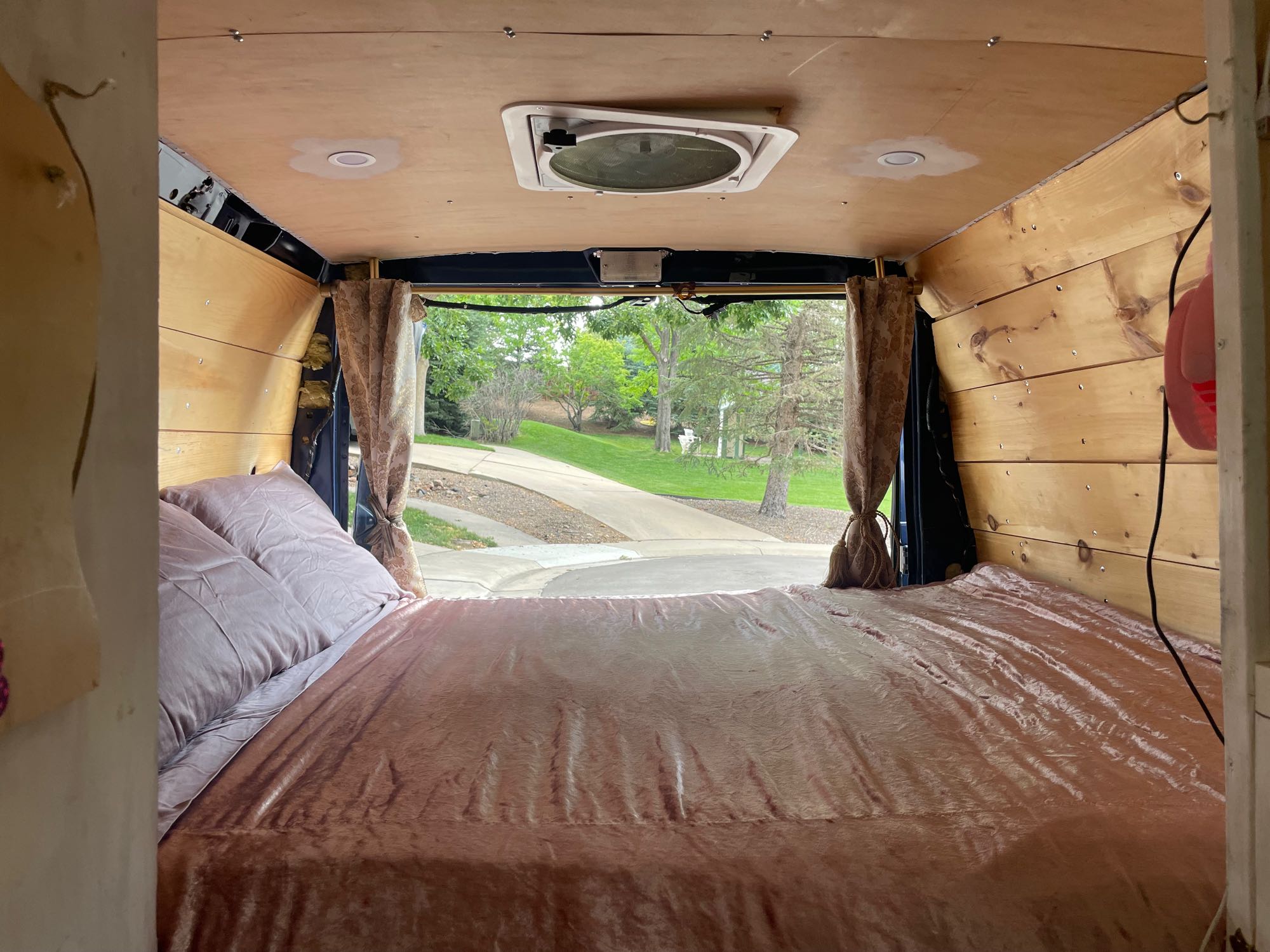 Explore in comfort with this RV rental! Features a soft bed, wood-paneled interior, and a clear view out the back.. Ford Econoline 2010