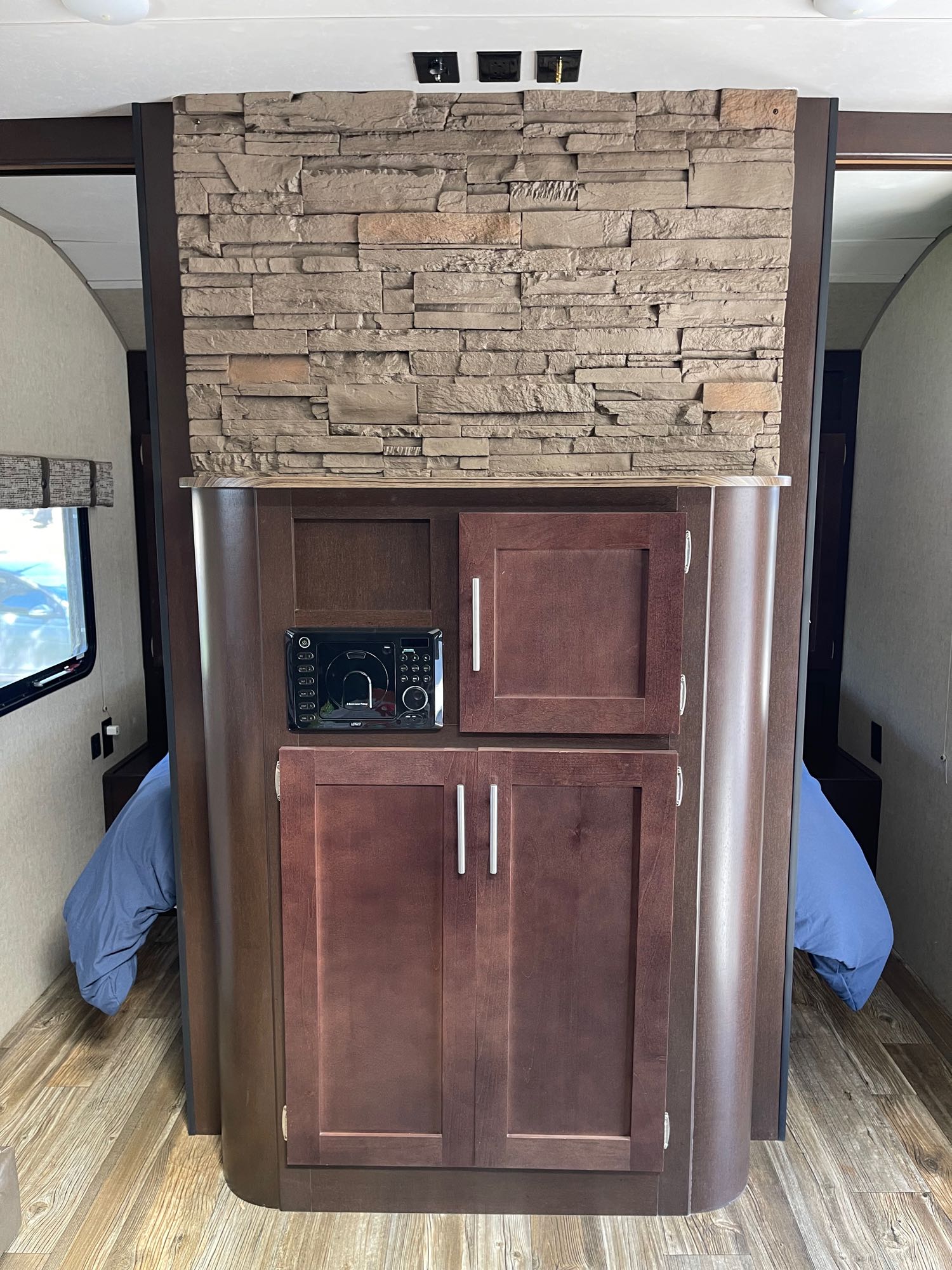 RV rental: Faux stone & wood interior partition with media player, cabinets, & sleeping areas.. Forest River Cherokee Grey Wolf 2017