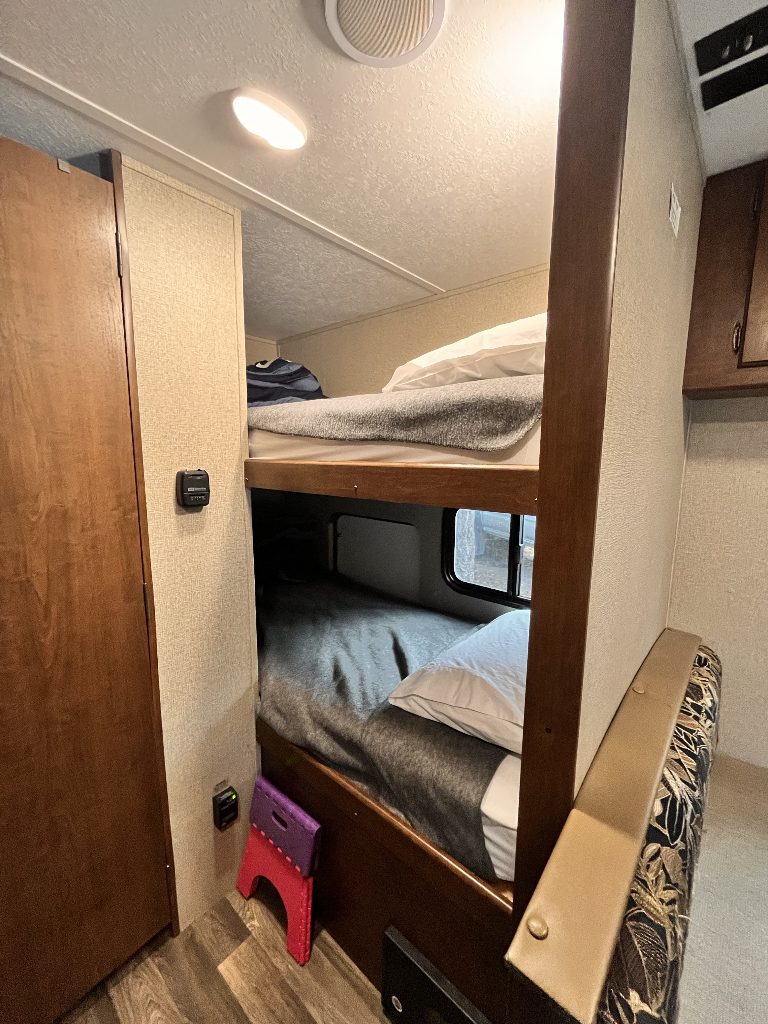 Inside an RV rental: a compact sleeping area with upper and lower bunk beds, ideal for maximizing space for travelers.. Keystone RV Hideout 2017