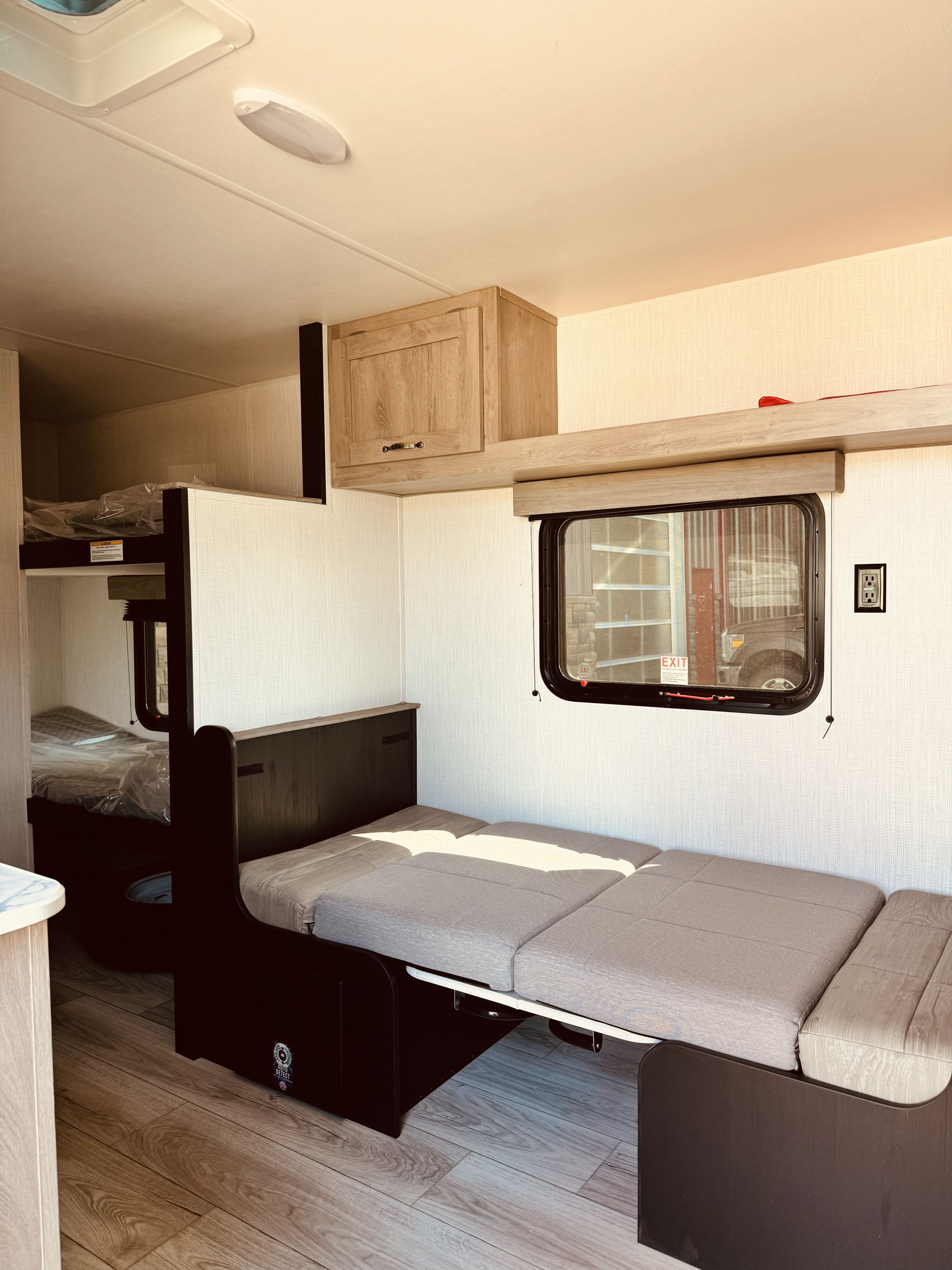 Clean RV rental interior showing a convertible dinette and bunk beds, offering compact living and sleeping space.. Cruiser RV Avenir 2024