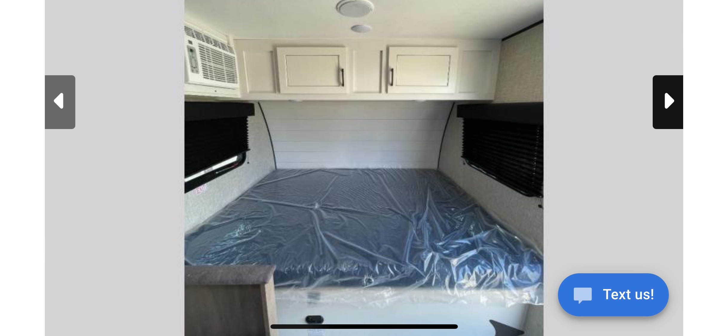 RV rental: Travel trailer bedroom with a protected bed, AC unit, and overhead storage cabinets.. Jayco Jay Flight SLX 2024