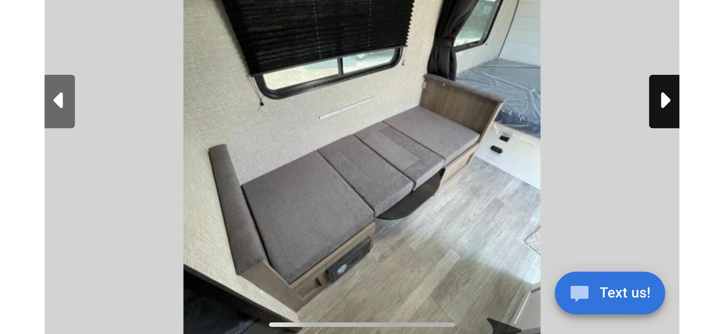 RV rental interior: Cozy grey dinette/sofa converts to a bed, with window blinds and wood-look flooring.. Jayco Jay Flight SLX 2024