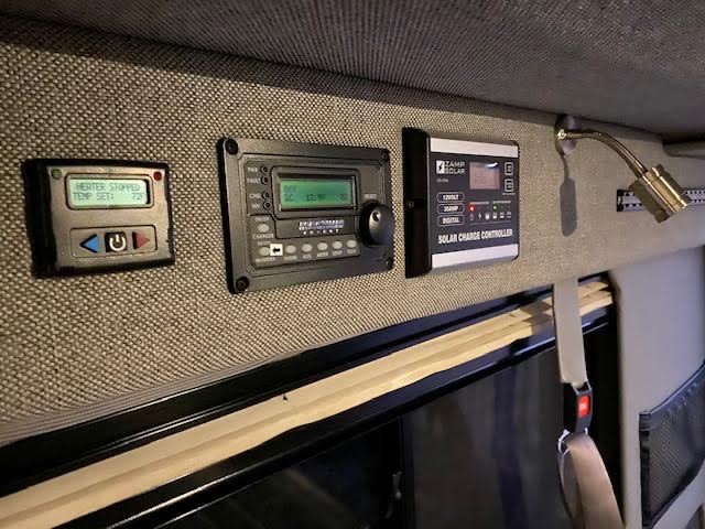 RV rental interior with control panels for heating, Xantrex inverter, and Camp Solar charge controller. Manage power for comfort.. Mercedes-Benz Sprinter 2017