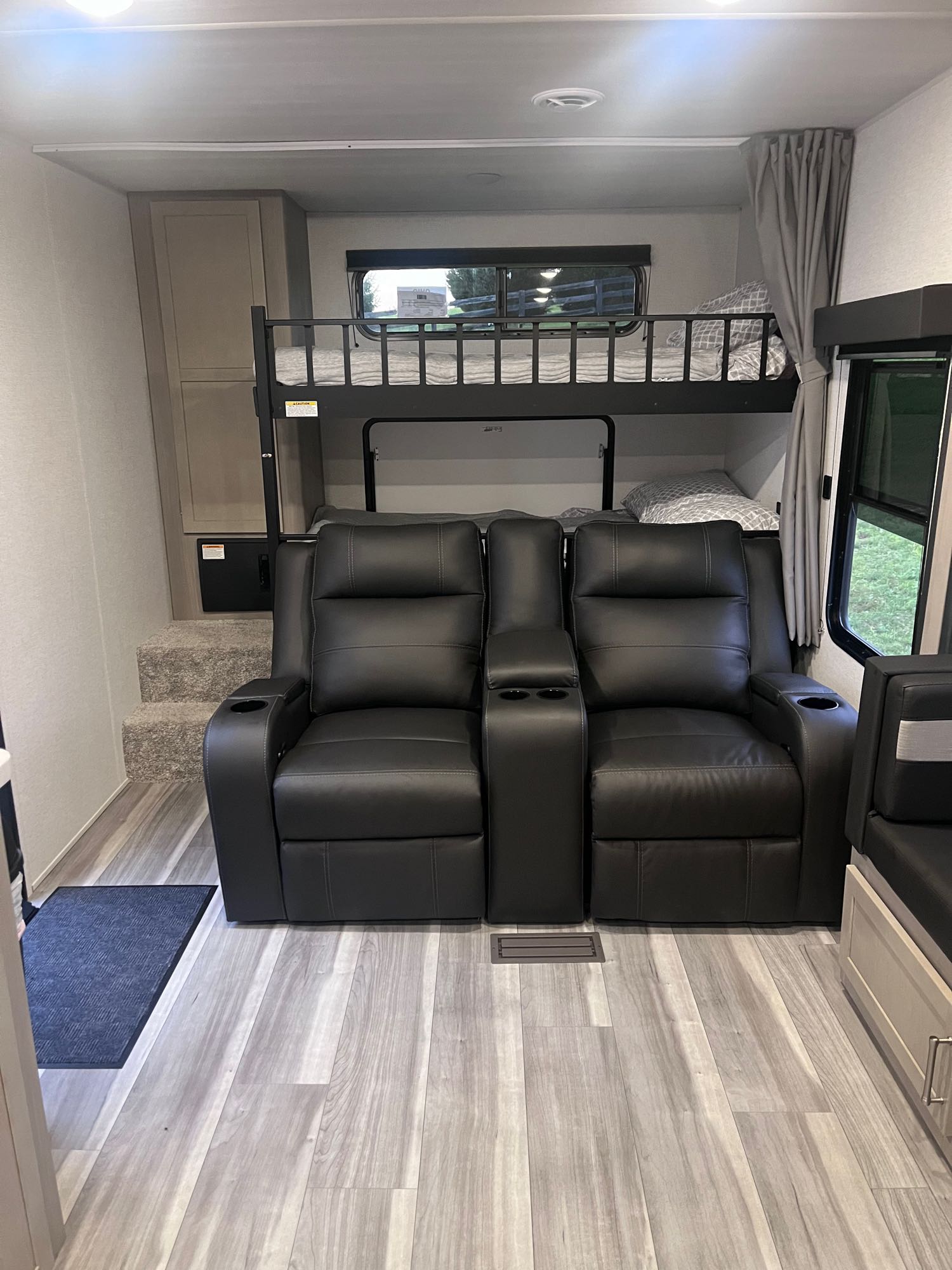 Experience comfort in this RV rental with dual bunk beds, plush recliners, and wood-look flooring.. Keystone RV Springdale 2024