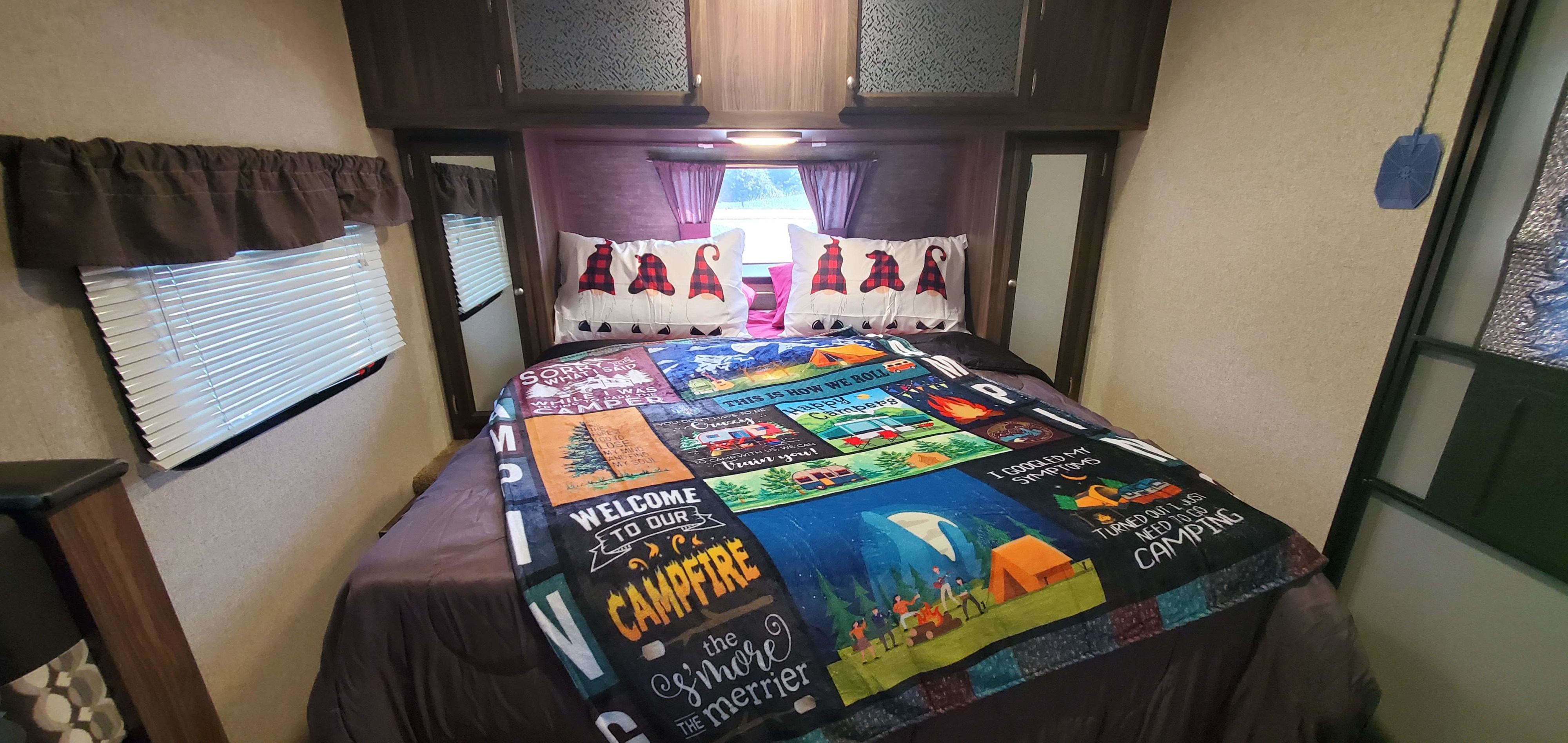 Cozy RV rental bedroom with a fun camping blanket & gnome pillows. Perfect for your next adventure!. Coachmen Apex Nano 2018