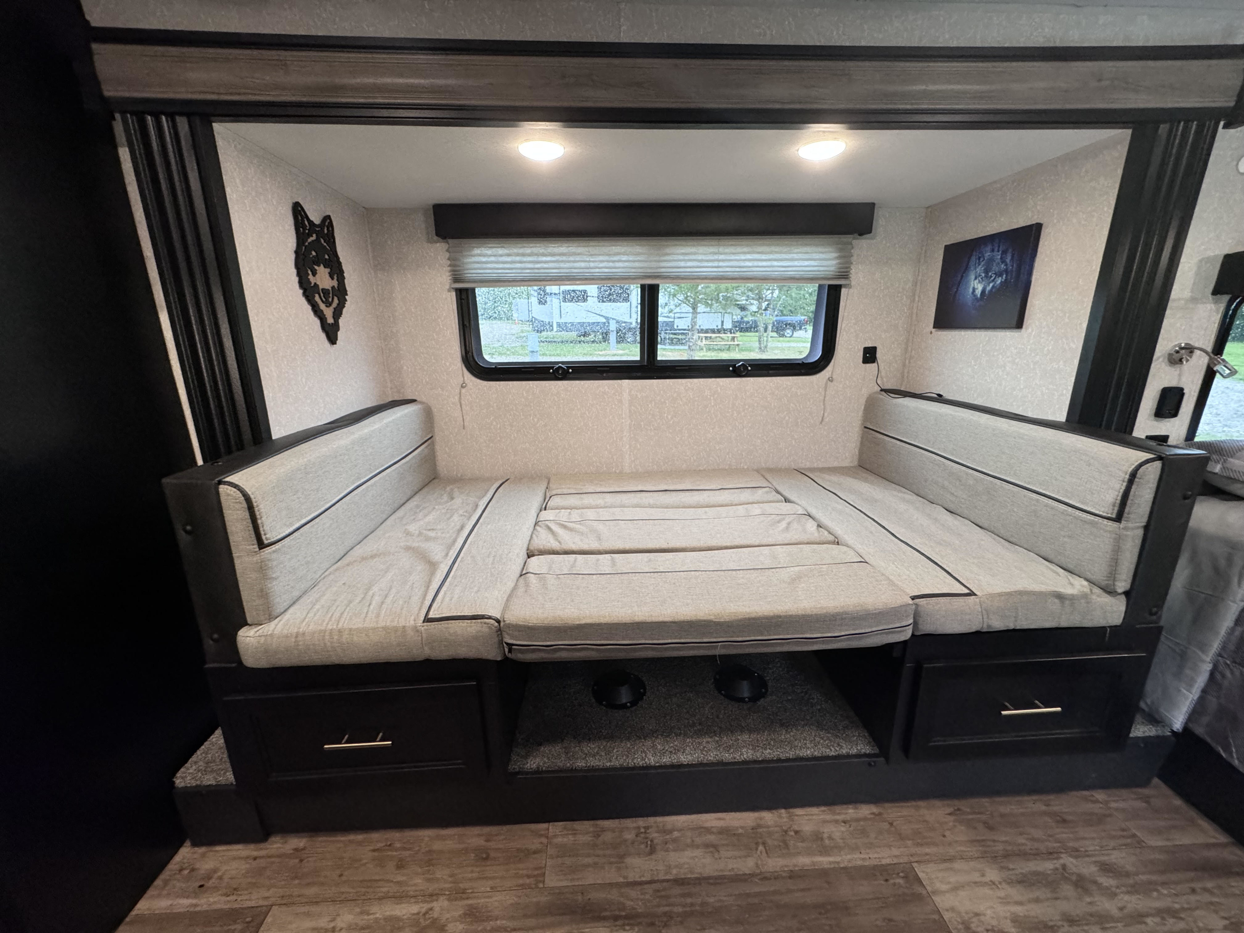 RV rental: Convertible dinette bed, cozy wolf decor, and window views. Ideal for your next adventure!. Forest River Cherokee Wolf Pup Black Label 2022