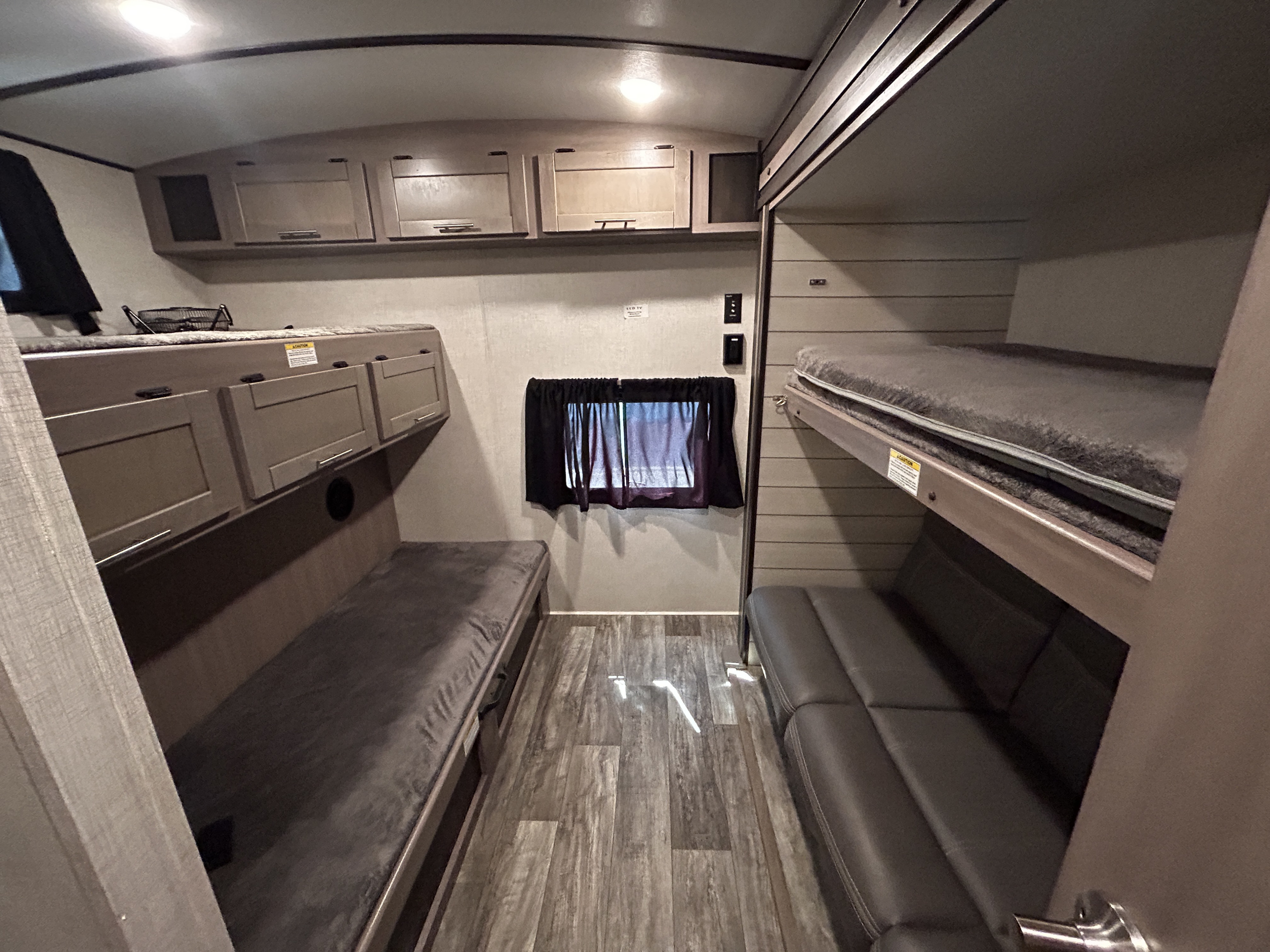 This RV rental offers a compact and functional interior with multiple bunk beds, a comfortable sofa, and overhead storage.. Crossroads Sunset 2021