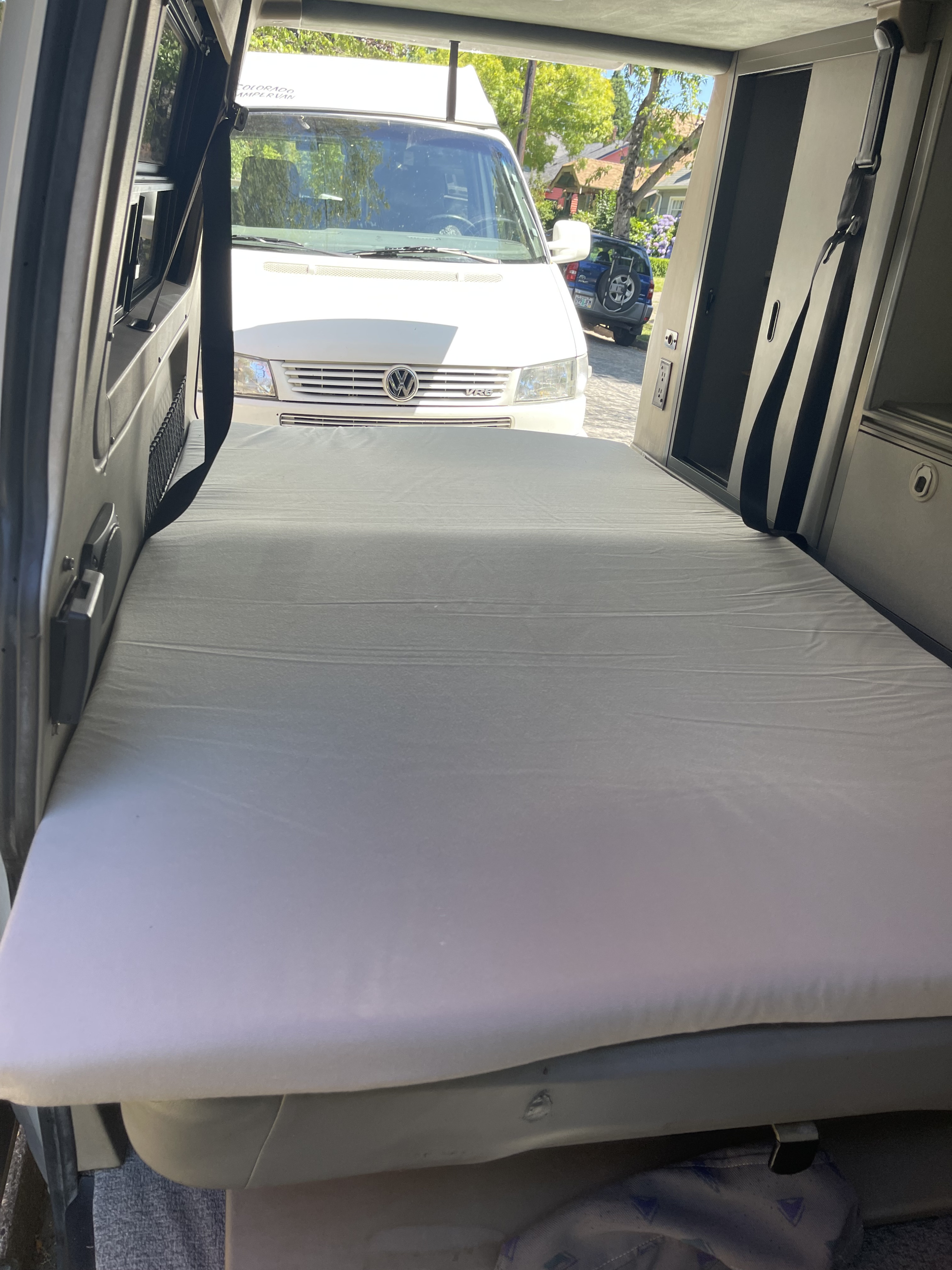 Inside a cozy RV rental: a comfortable bed ready for road trips & adventure.. Volkswagen Winnebago Leisure Seeker 1999