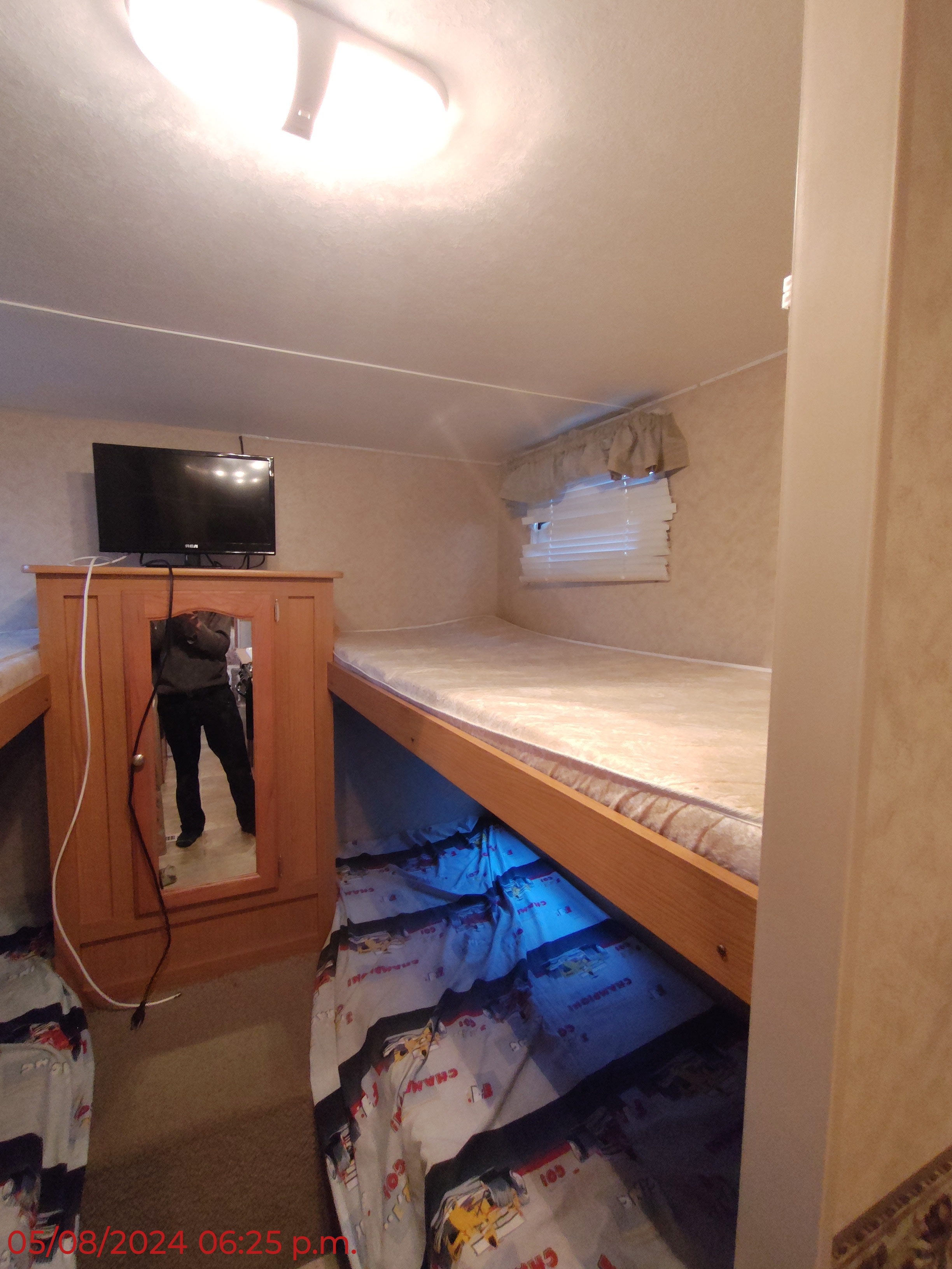 RV rental interior featuring bunk beds, a TV, and a mirrored cabinet. Cozy sleeping area with unique lighting.. Dutchmen Dutchmen 2007