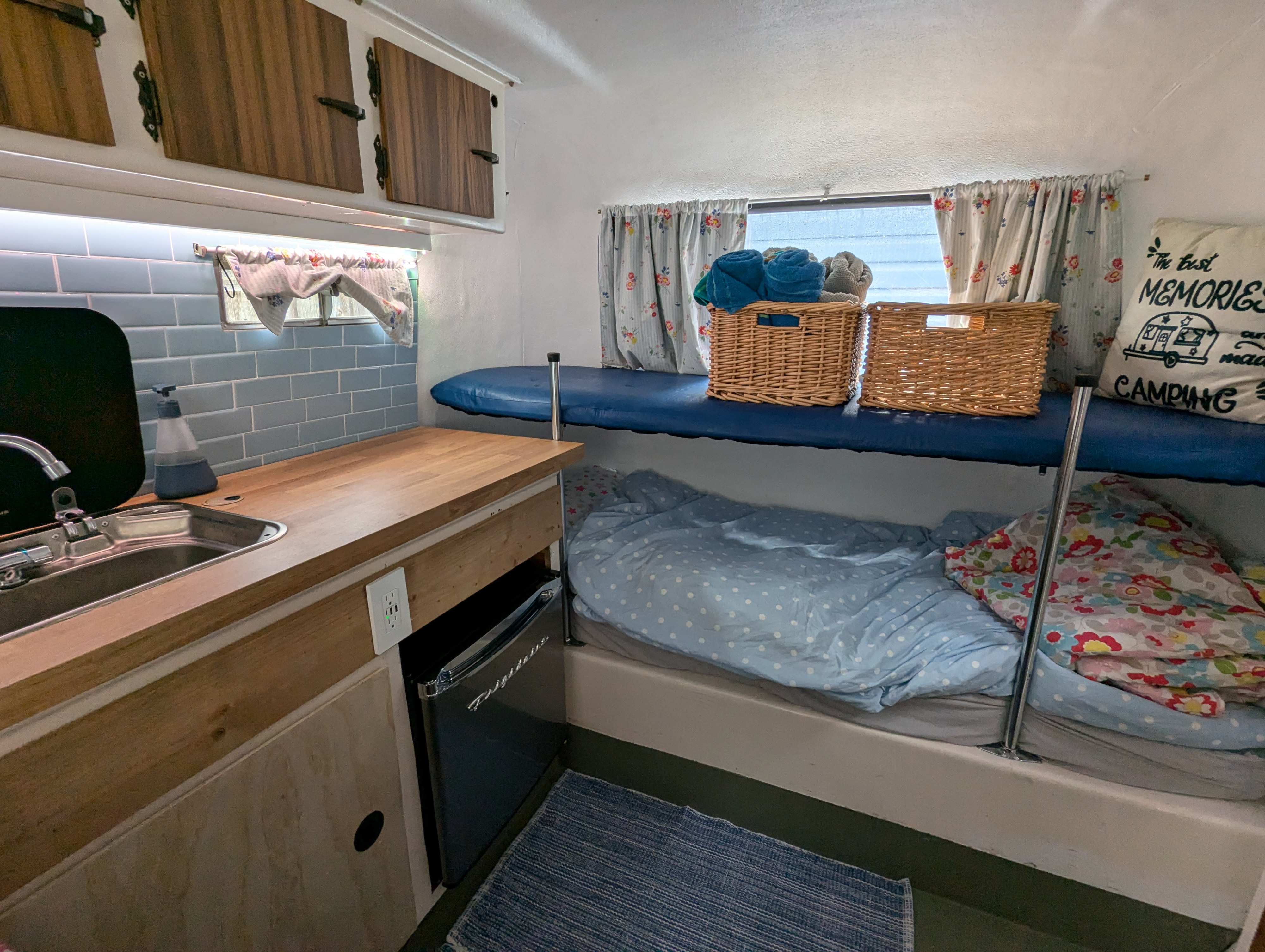 Cozy RV rental interior: compact kitchen, sink, and comfy bunk beds for camping adventures.. Boler Boler 1300 1974