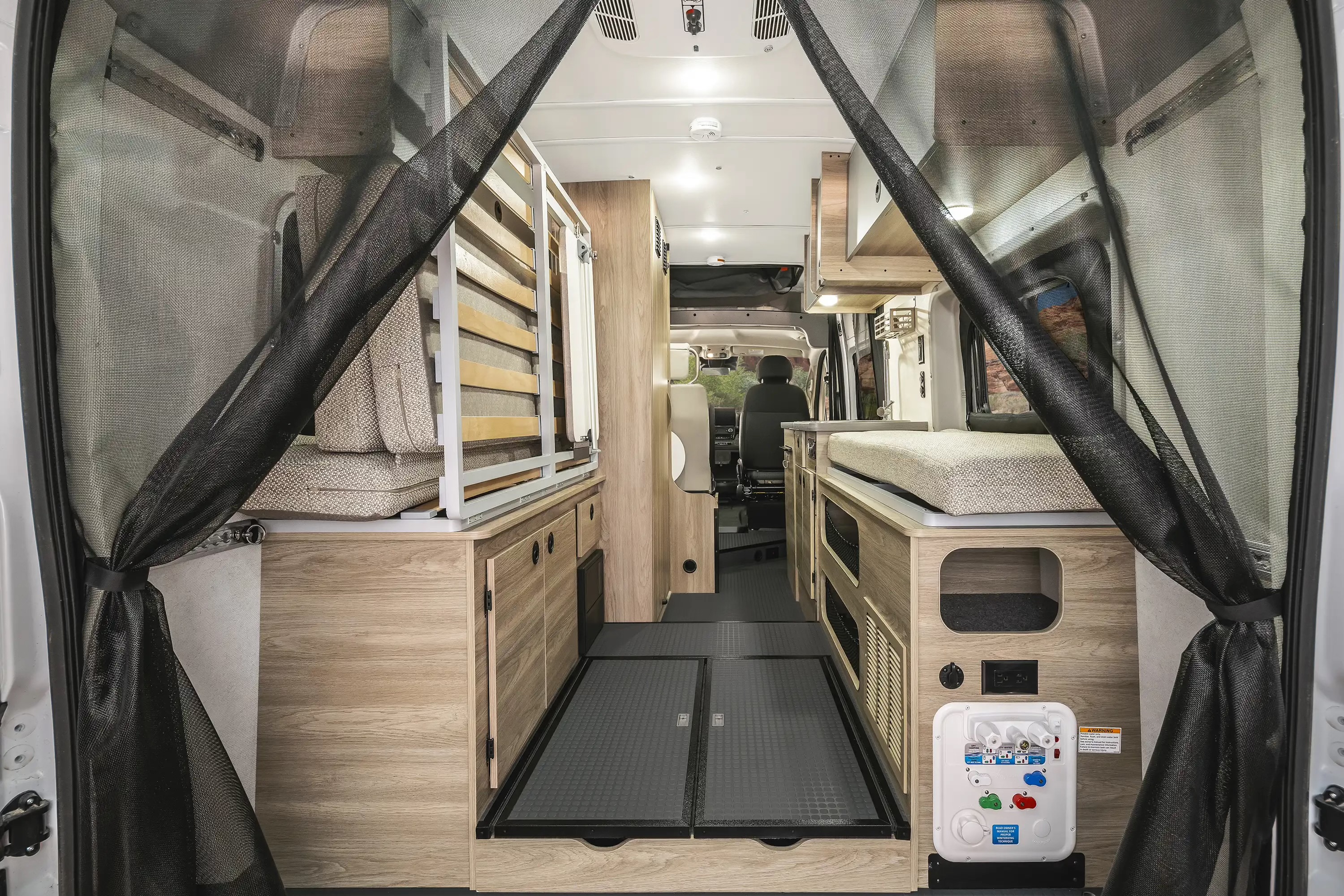 Step inside a modern rv rental! This camper van features smart storage, comfortable beds, and practical mesh rear door screens.. Winnebago Solis 2023