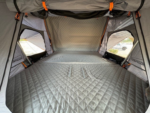 Spacious Roofnest rooftop tent interior, offering a comfortable sleep on quilted mattress. Great RV rental alternative.. Rustic Mountain Overland Patrol XCT 2022