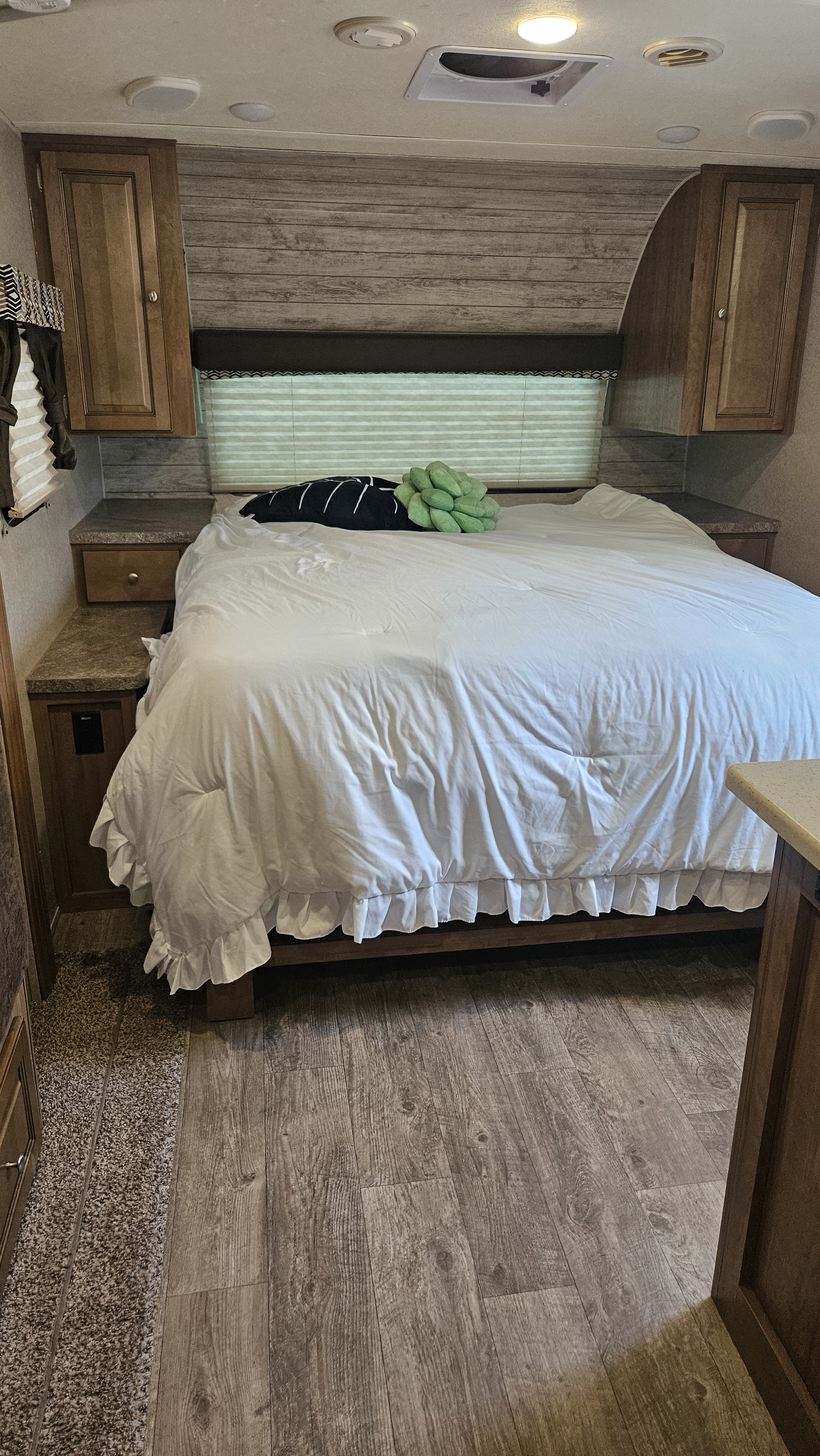 Cozy RV rental bedroom with wood accents, a comfy bed, and ample storage for your mobile retreat.. Forest River Rockwood Mini Lite 2019