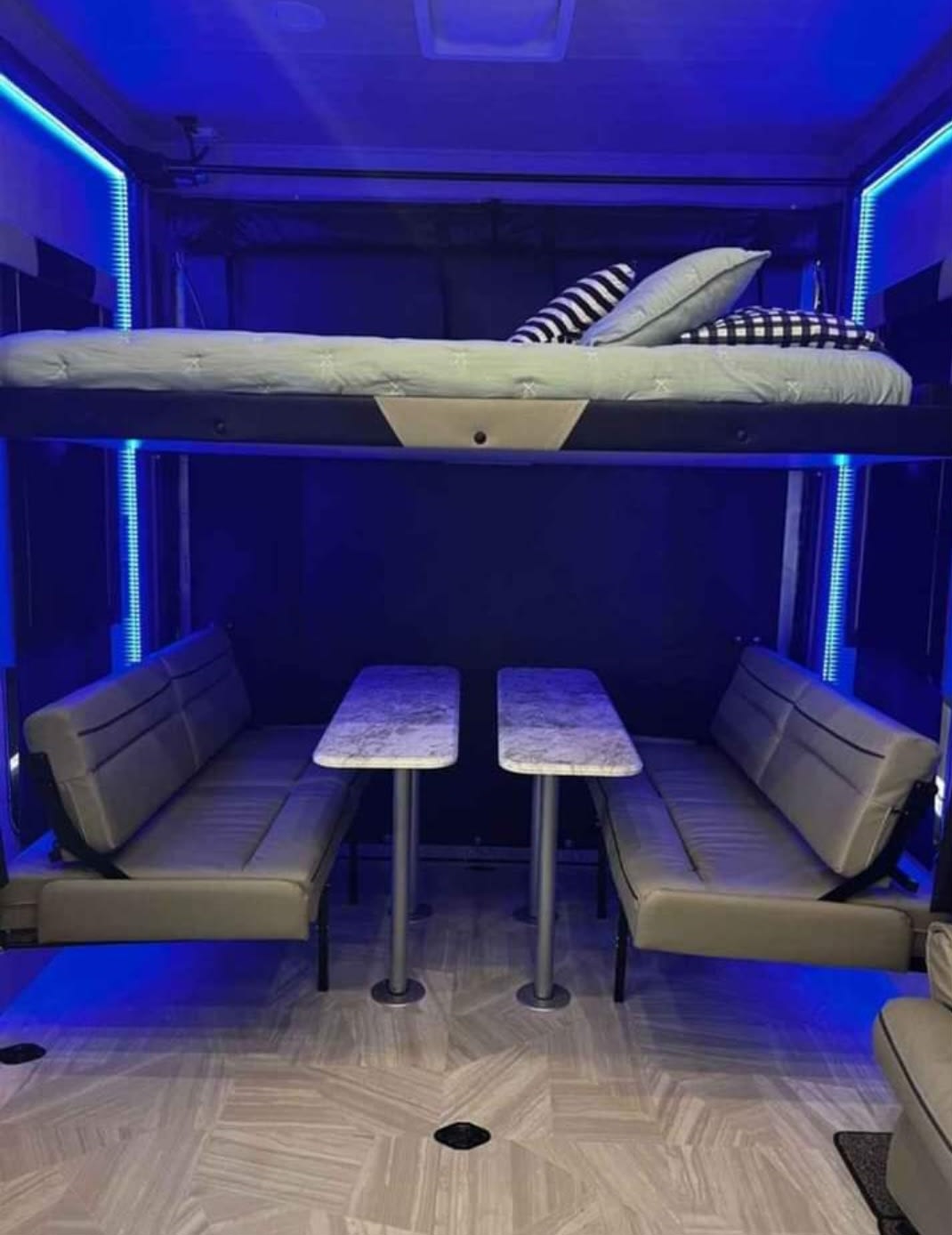 RV rental: flexible interior with elevated bunk bed, lower dining area, and blue LED lights.. GENESIS MGM 2021
