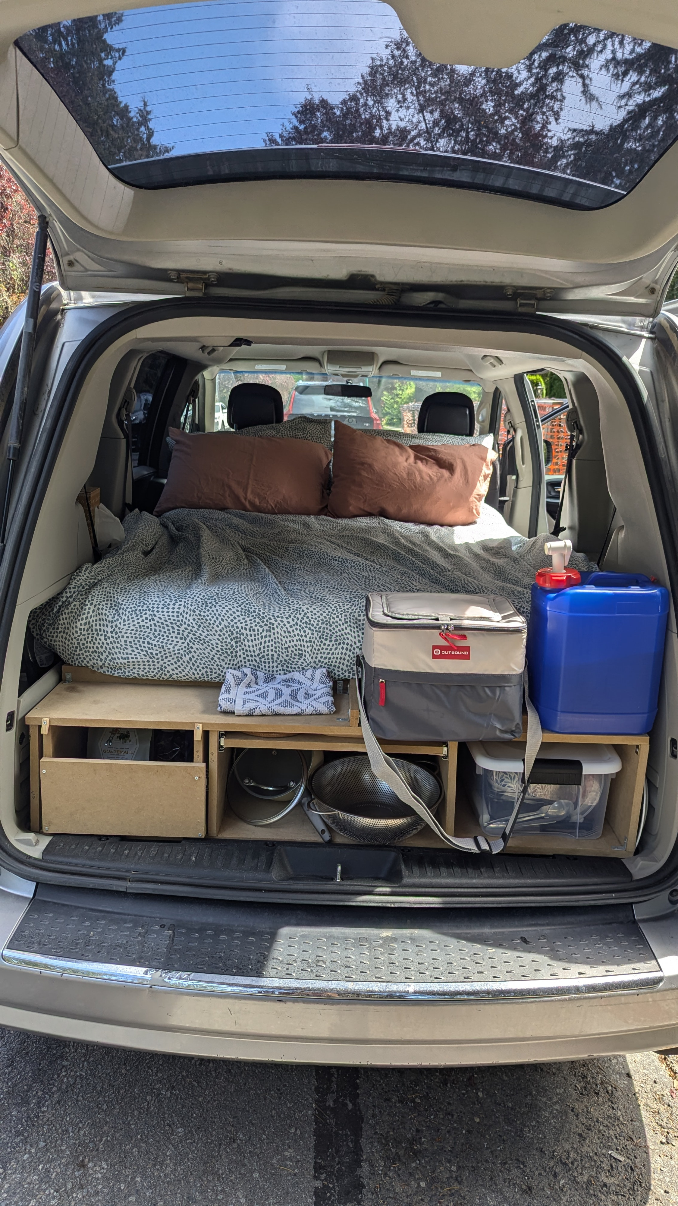 Minivan car camping setup with bed & kitchen storage. Ideal DIY RV rental for adventure travel & van life!. Dodge Grand Caravan 2014