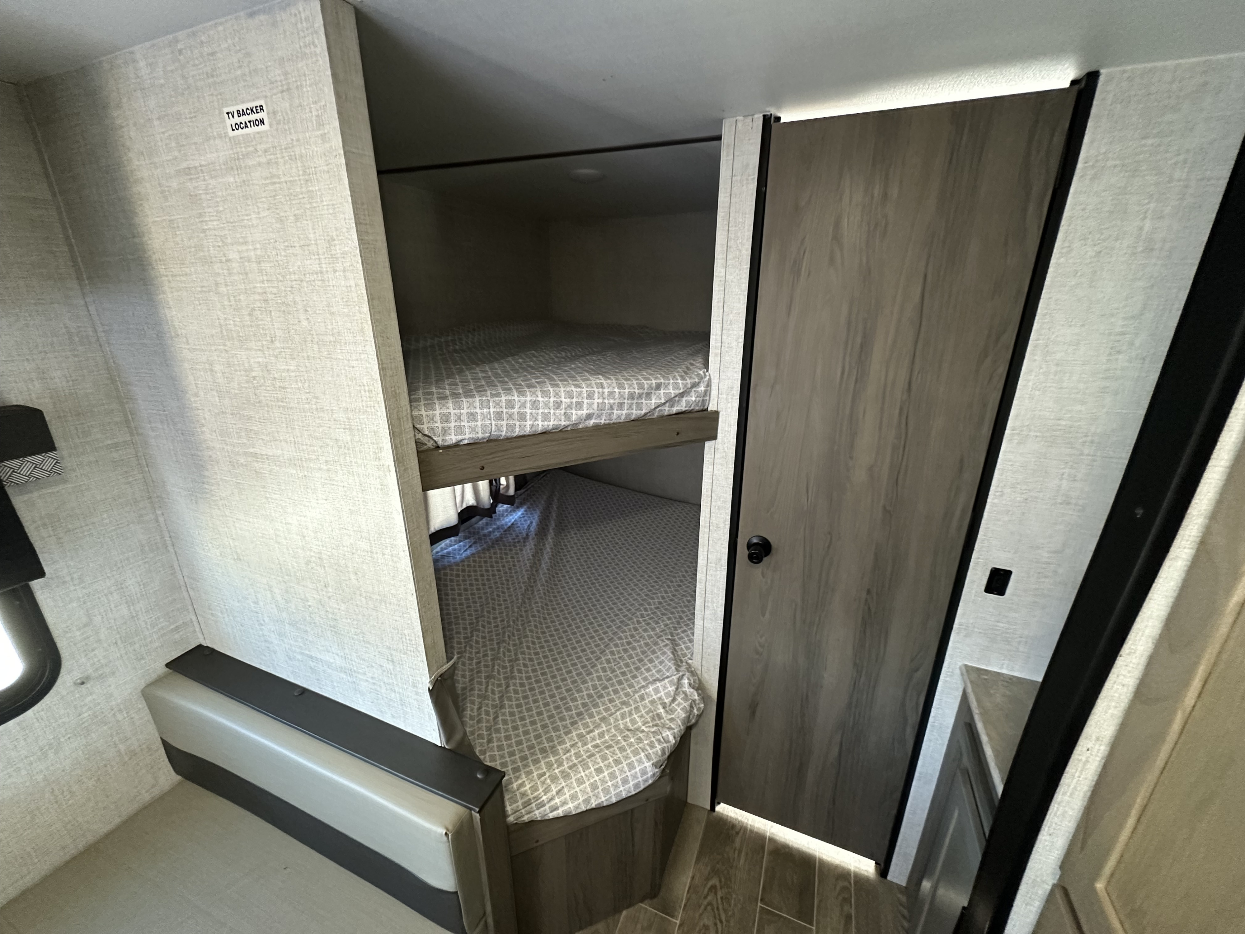 RV rental: Compact interior with comfy bunk beds & designated TV backer location for entertainment setup.. Gulf Stream Kingsport 2022
