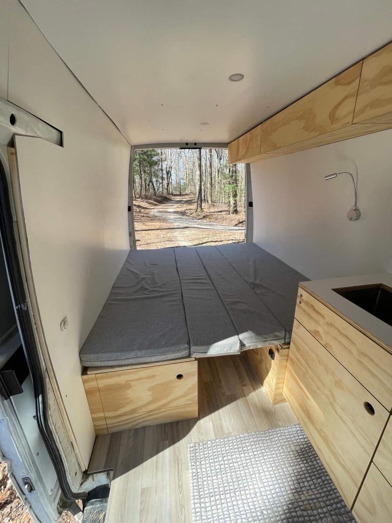 RV rental van conversion interior: fold-out bed, plywood storage, and kitchen area. Ready for adventure!. Dodge Sprinter 2005